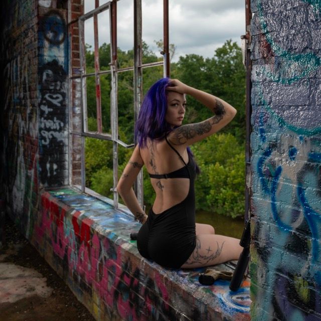 Creative environmental portrait of a woman photographed in an urban graffiti location in Sanford, NC