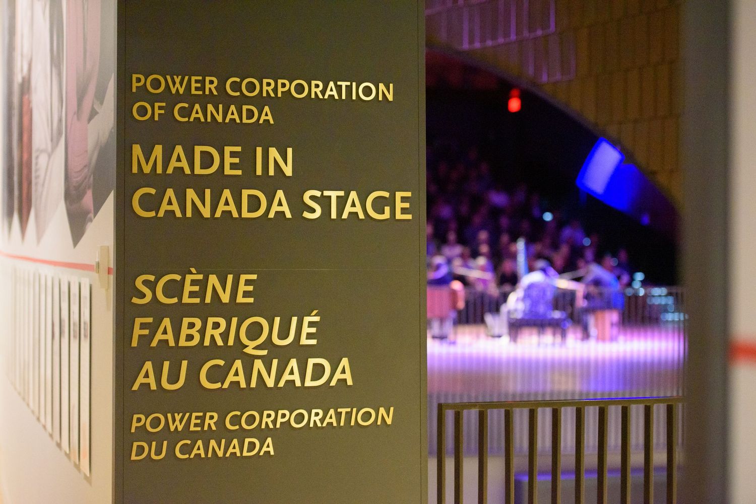 Power Corporation of Canada Made in Canada Stage bilingual signage at an event venue with blurred audience background.