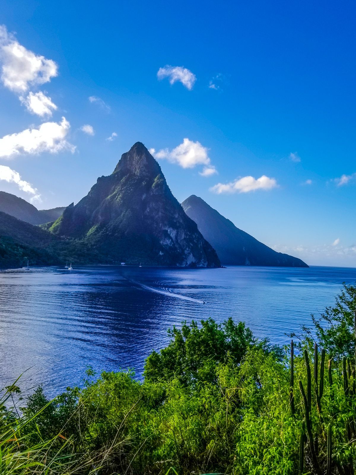 Scenic view of the Pitons volcanic peaks rising above blue Caribbean Sea in St. Lucia.