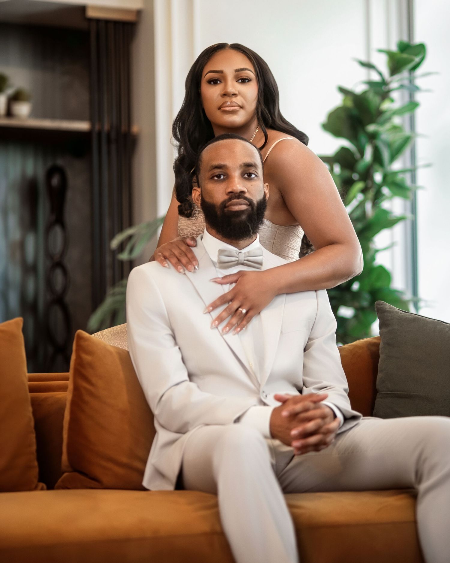 Couple embracing while seated together on a sofa in an elegant home