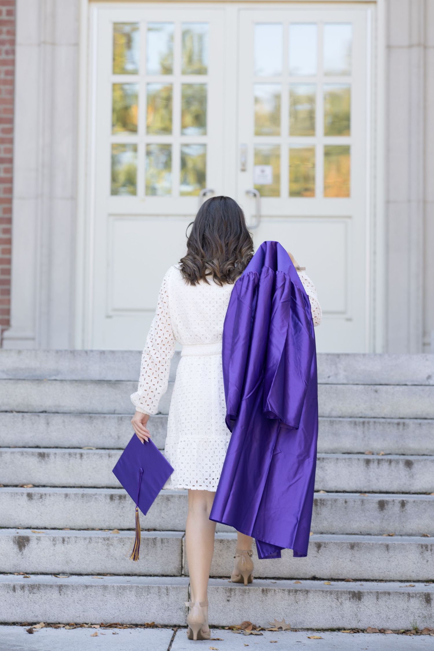 A series of four photos showing someone walking up concrete steps while holding a purple blazer.