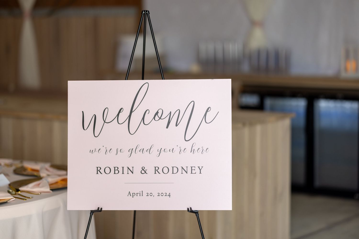 Elegant wedding welcome sign on easel reading Welcome Robin & Rodney, April 19, 2024, in script font.