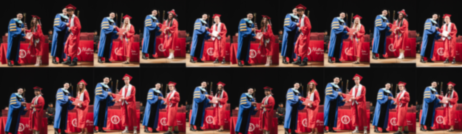 A row of performers in red outfits dance in synchronized formation on stage during a show.