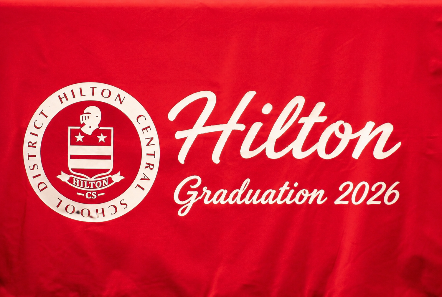 Red Hilton Central School District tablecloth featuring school crest and Hilton Graduation 2026 text.
