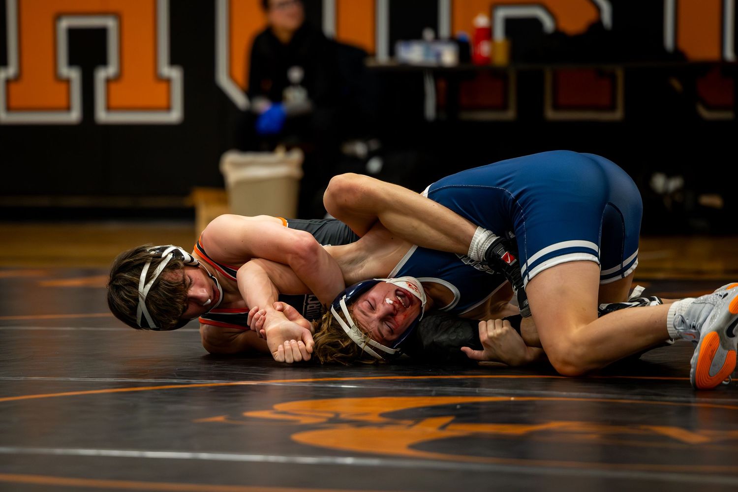 High school wrestlers compete in an intense match on a gymnasium mat. Studio portrait of a youth athlete. Team photos.