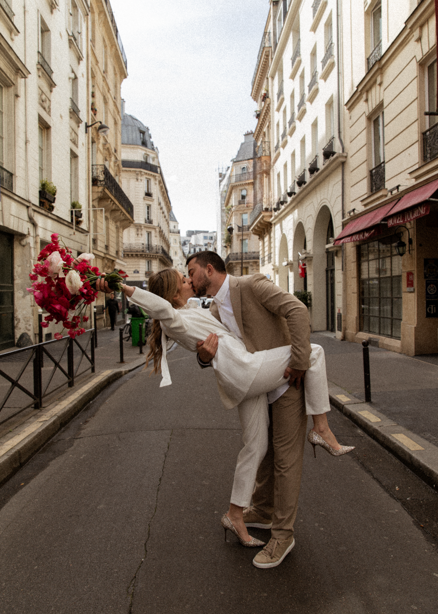 A playful wedding photo series showing a couple dancing in a charming Parisian street.