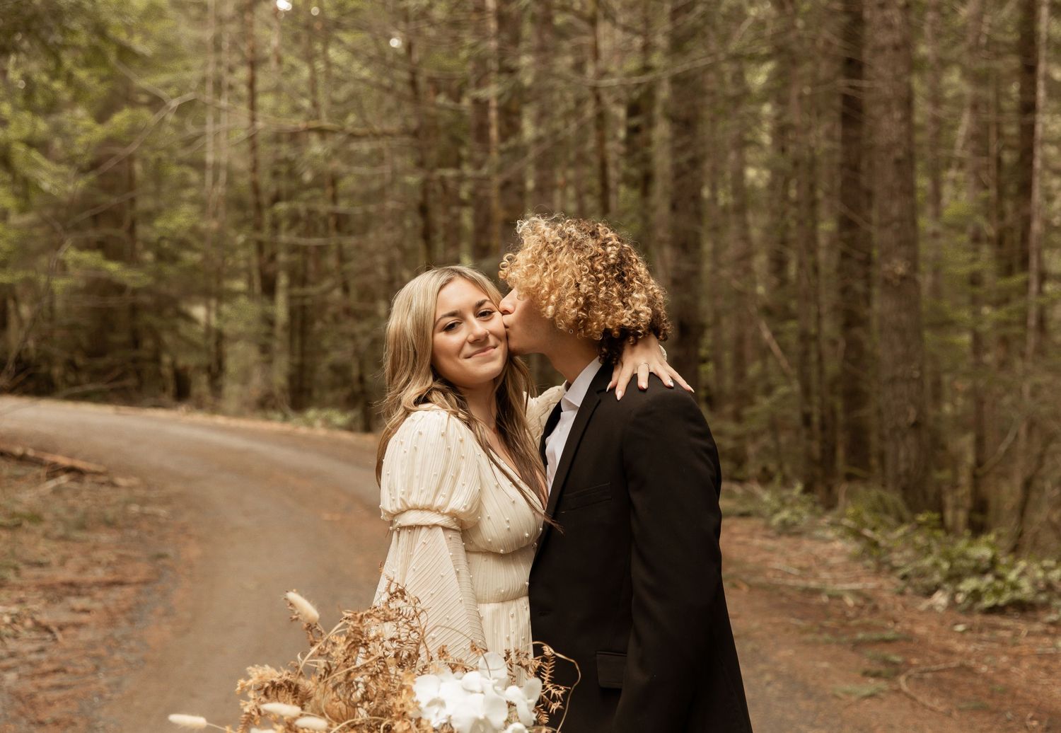 Intimate forest wedding photos captured on a serene woodland path.