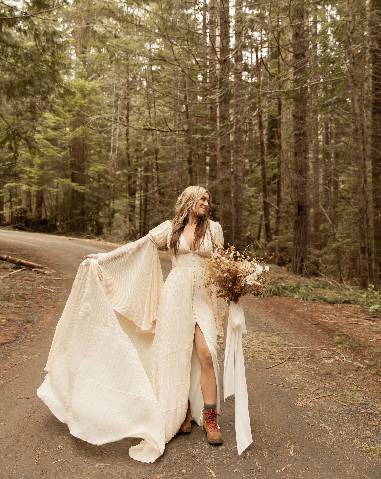 Ethereal wedding dress flowing in the breeze during a forest photoshoot.