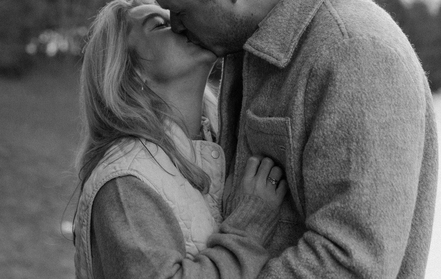Intimate black and white portrait of a couple sharing a tender moment.