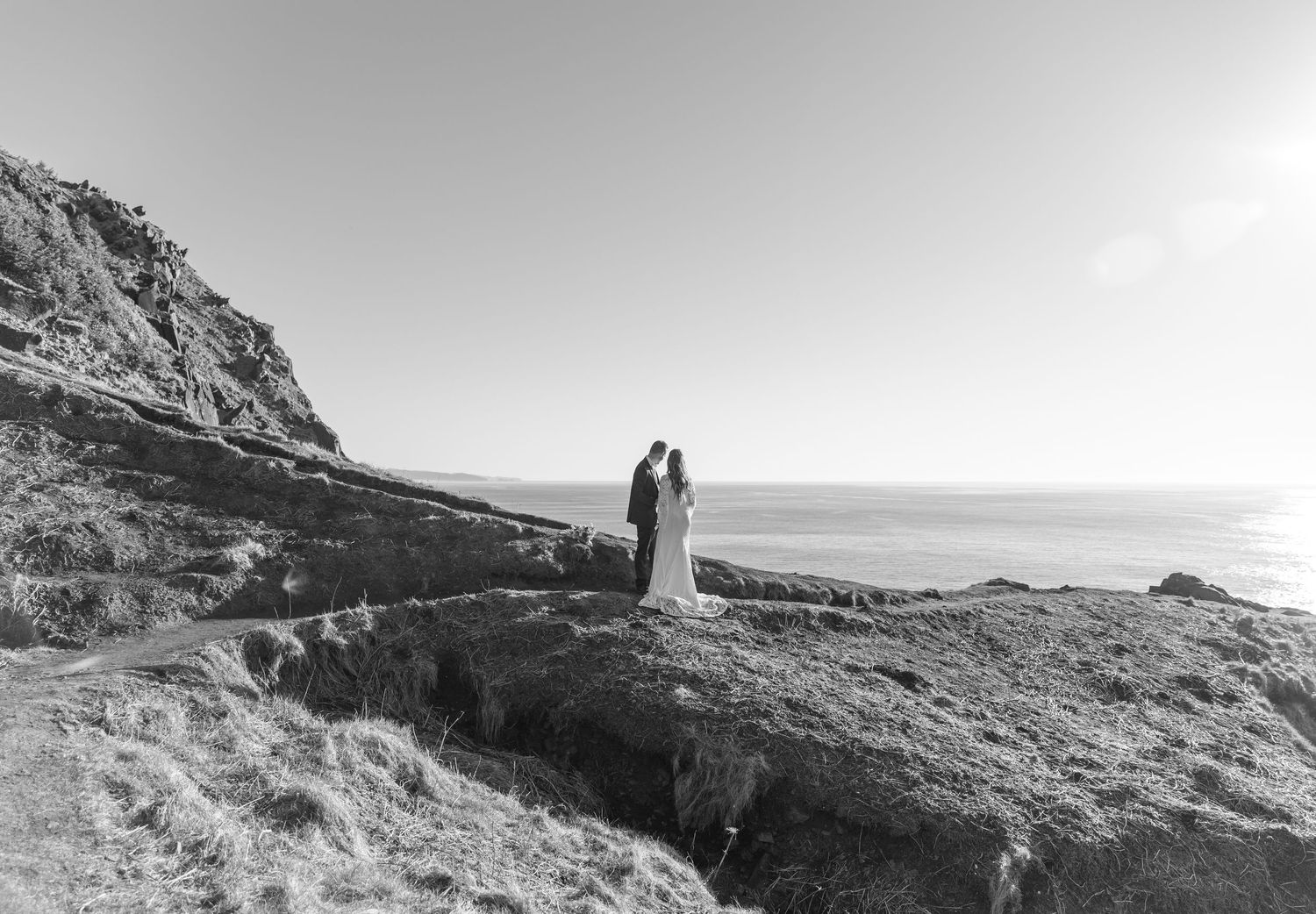 A series of black and white landscape photographs showing dramatic coastal cliffs and rocky shorelines.