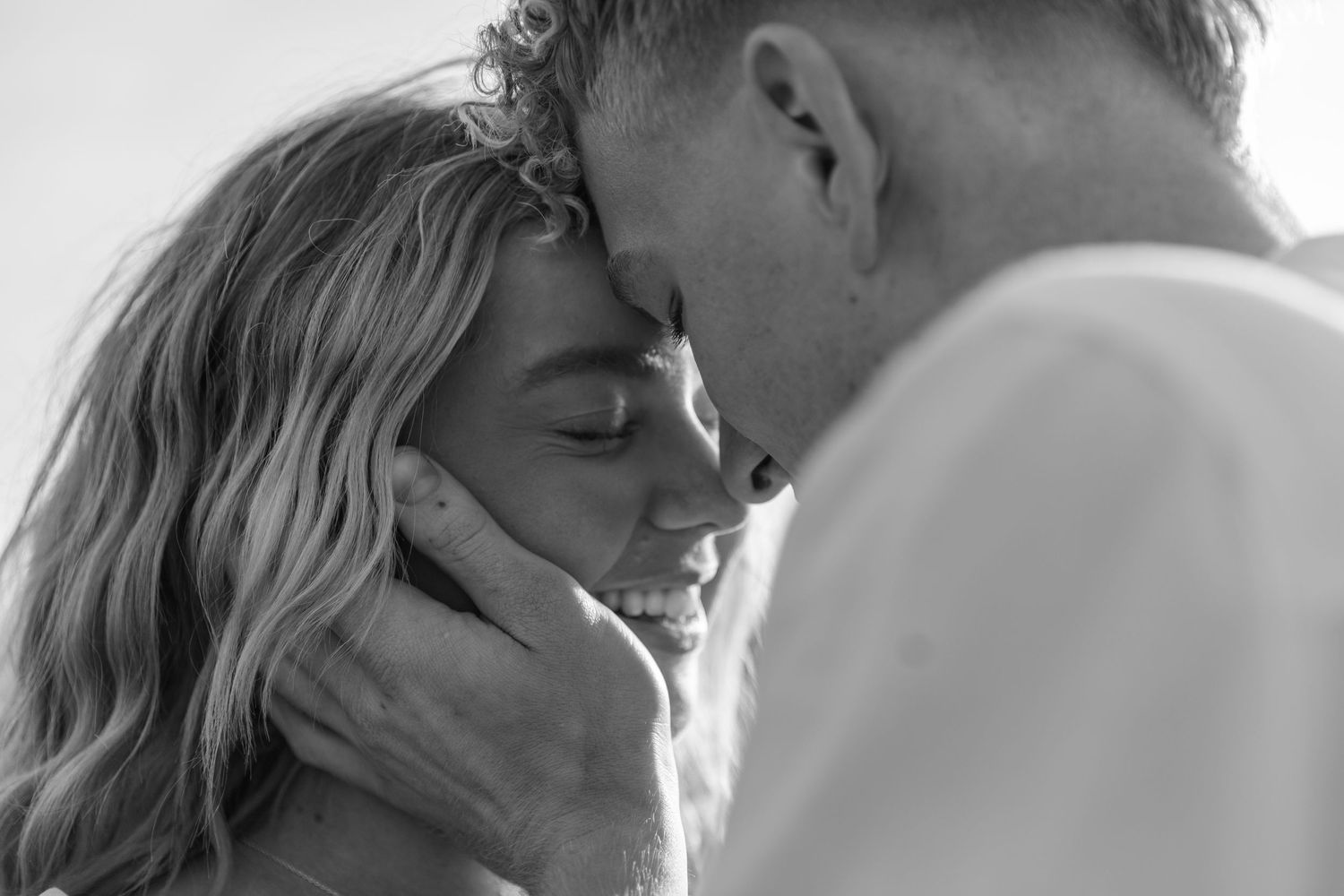 Black and white photo collage showing intimate moments between a couple in romantic poses.