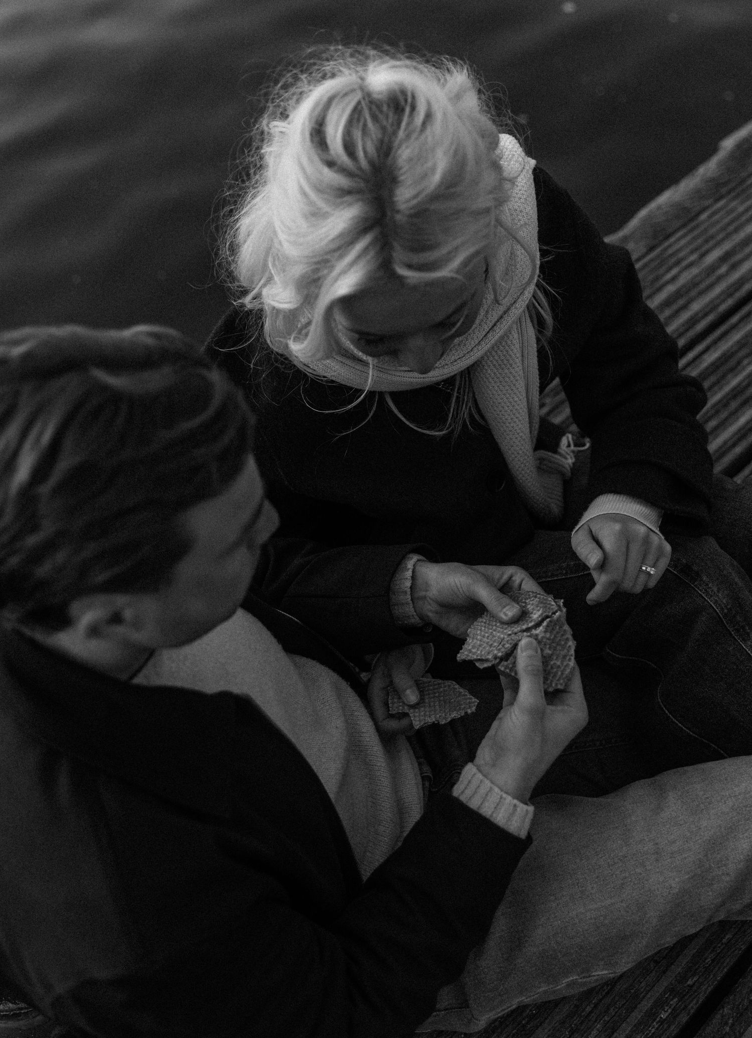 A series of black and white photographs showing intimate close-up shots of a couple in dramatic lighting.