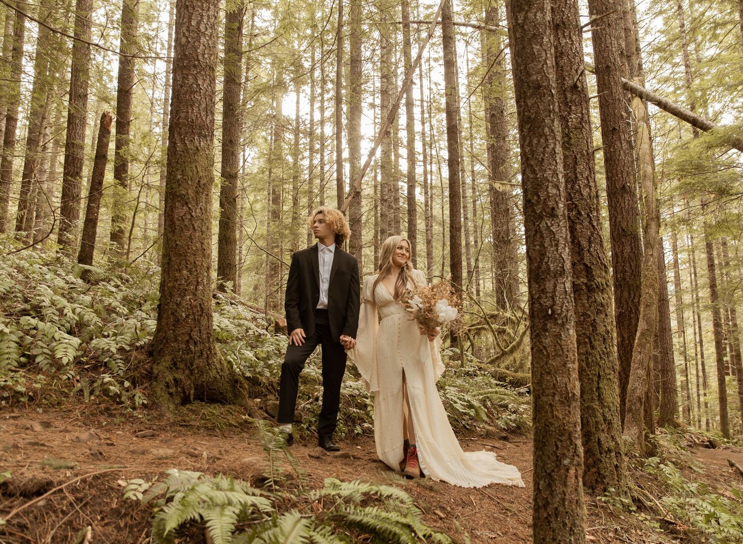 Wedding photography session in a majestic evergreen forest setting.