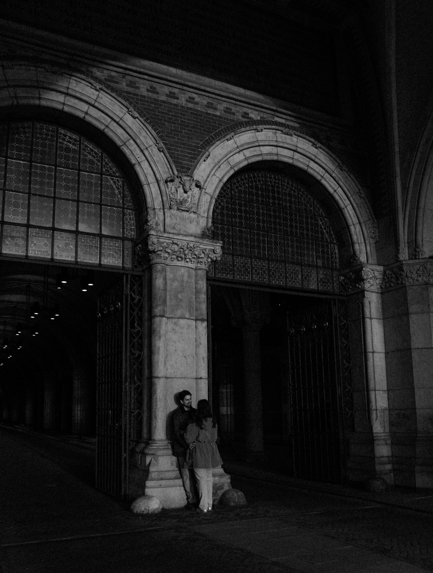 Dark archways with classical columns create dramatic architectural framing.
