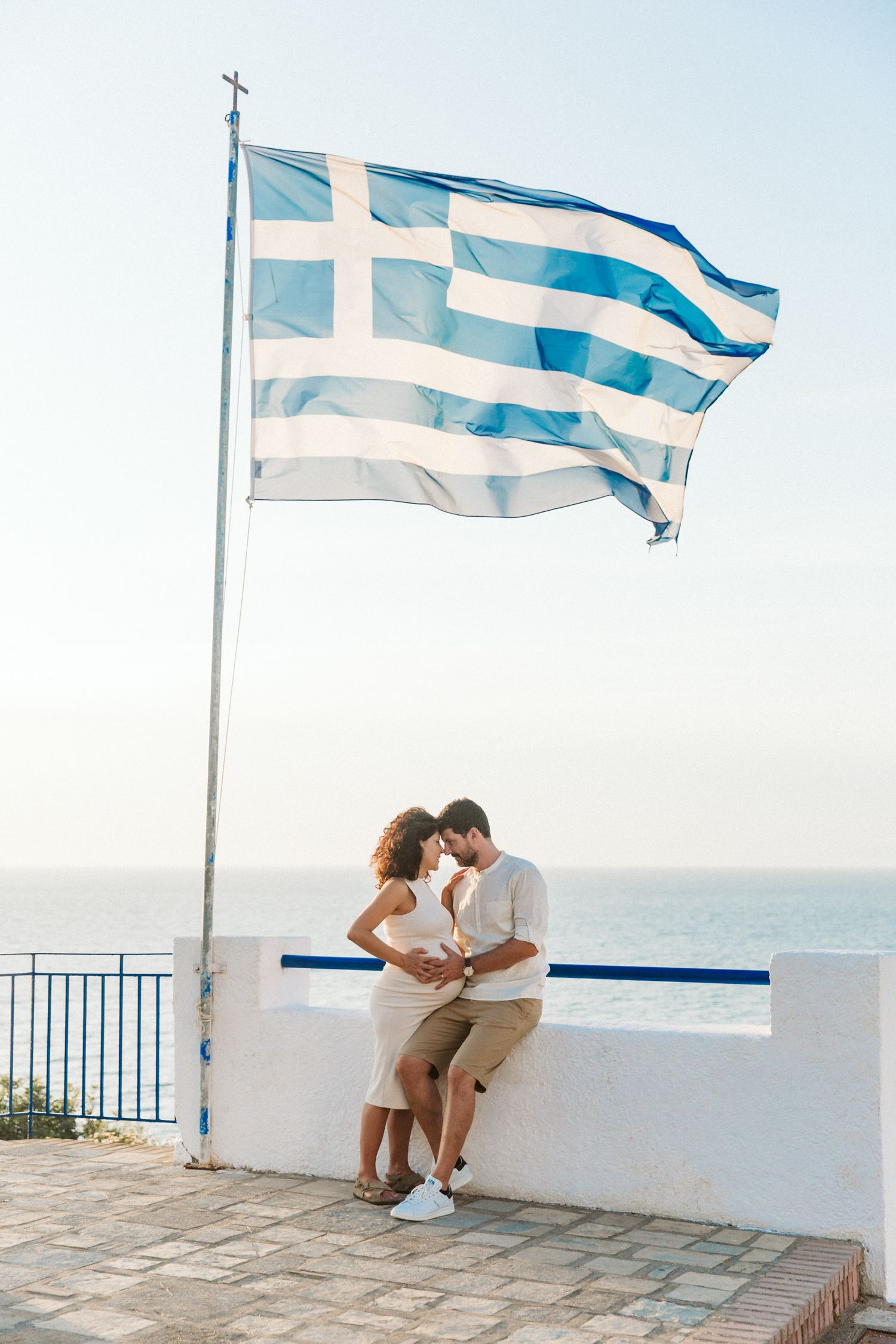 Romantic couples session in Samos at sunset with the Greek flag in the breeze