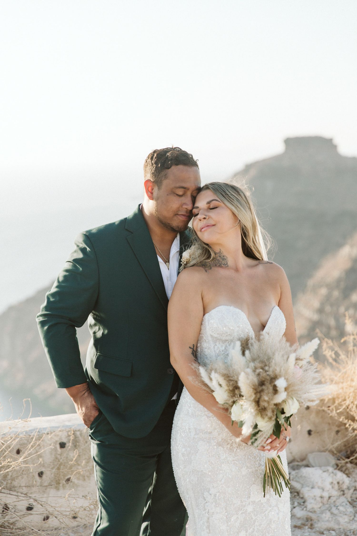 Bride and groom embracing in Santorini