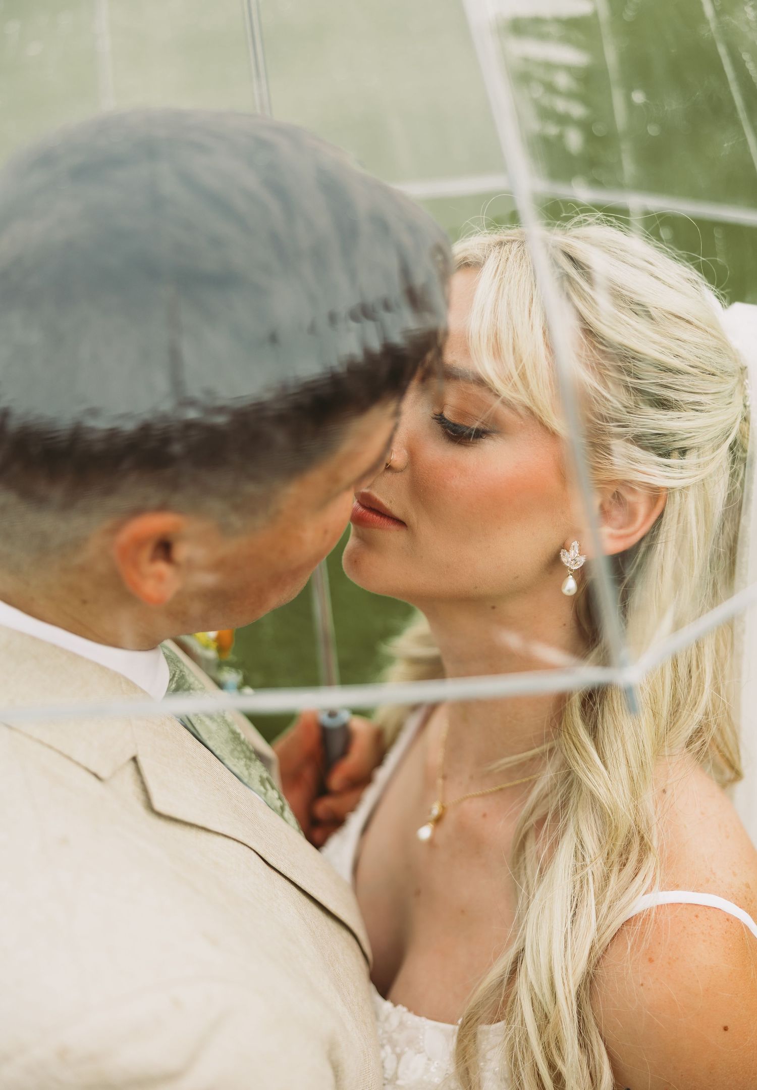 A romantic wedding couple shares tender kisses in a series of intimate outdoor portraits.