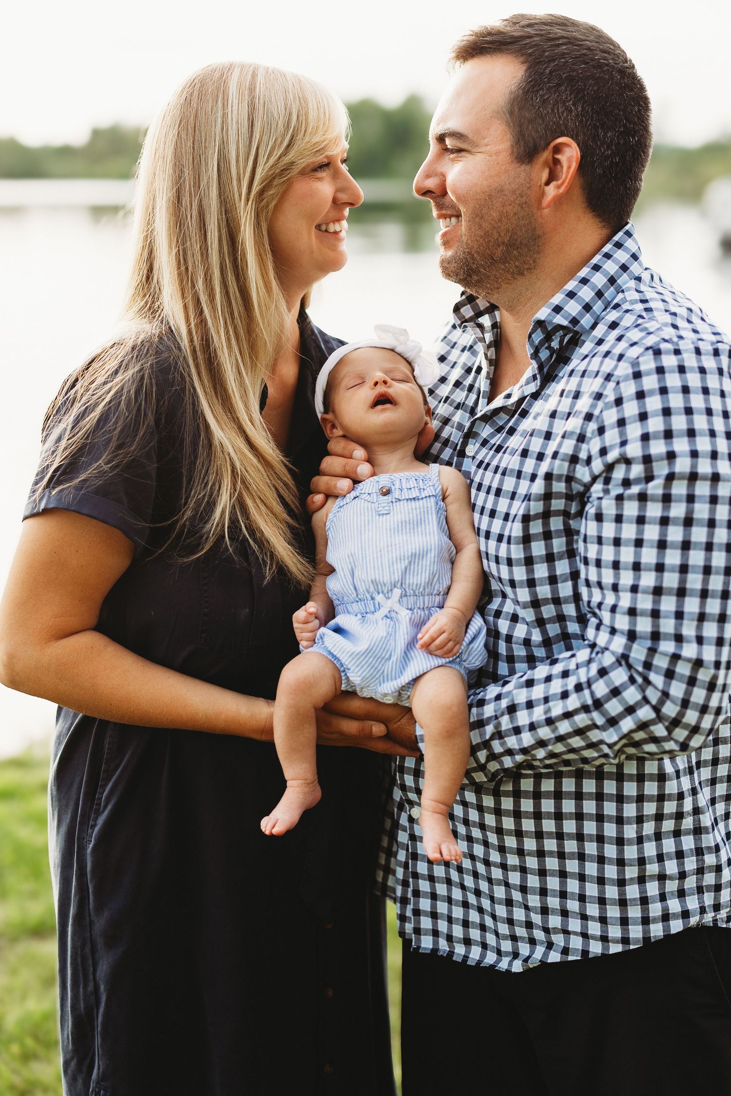 Family portrait series showing loving moments between parents and baby outdoors in natural lighting.