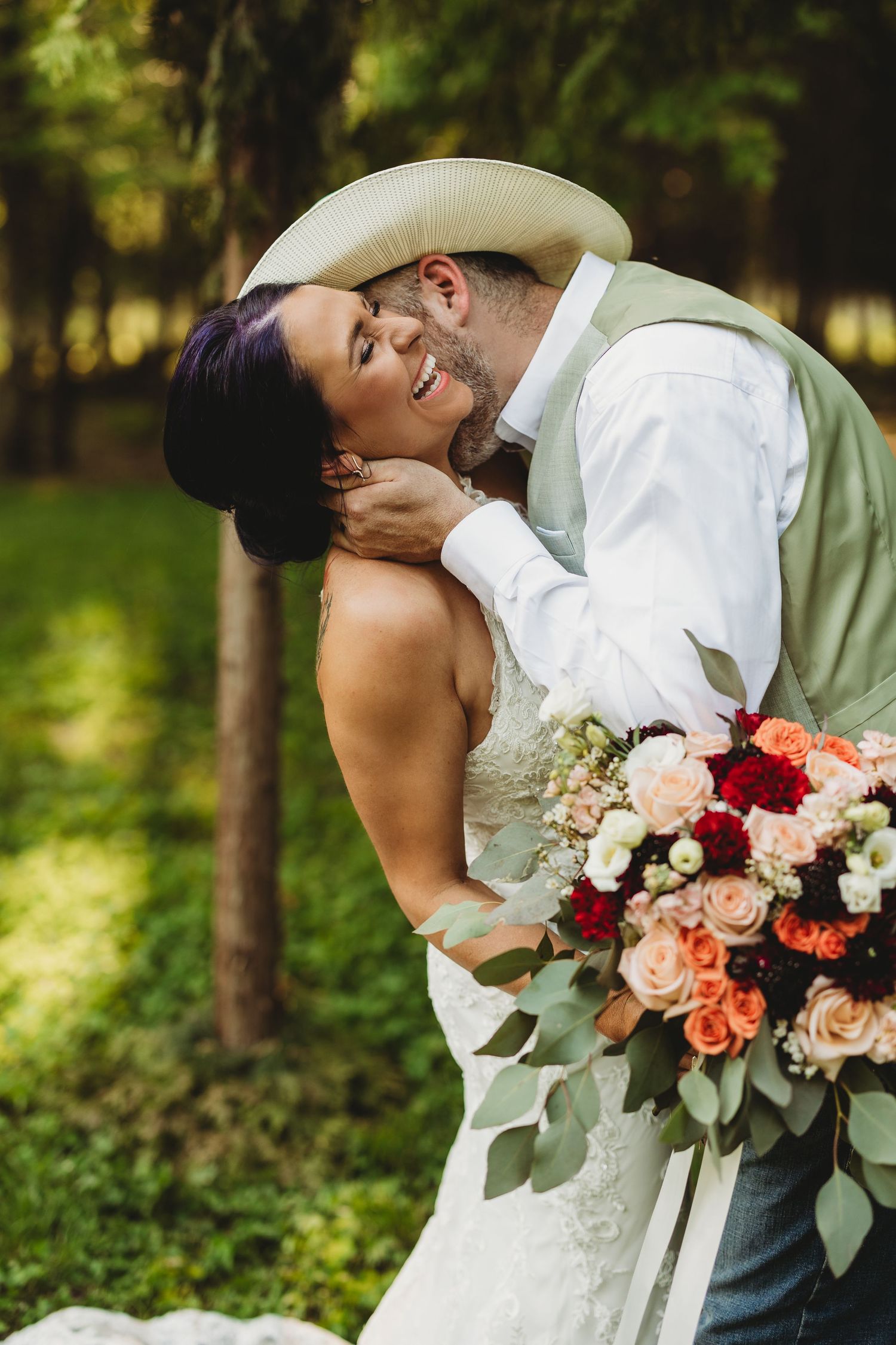 Intimate wedding portraits showing affectionate moments between the couple surrounded by natural outdoor scenery.