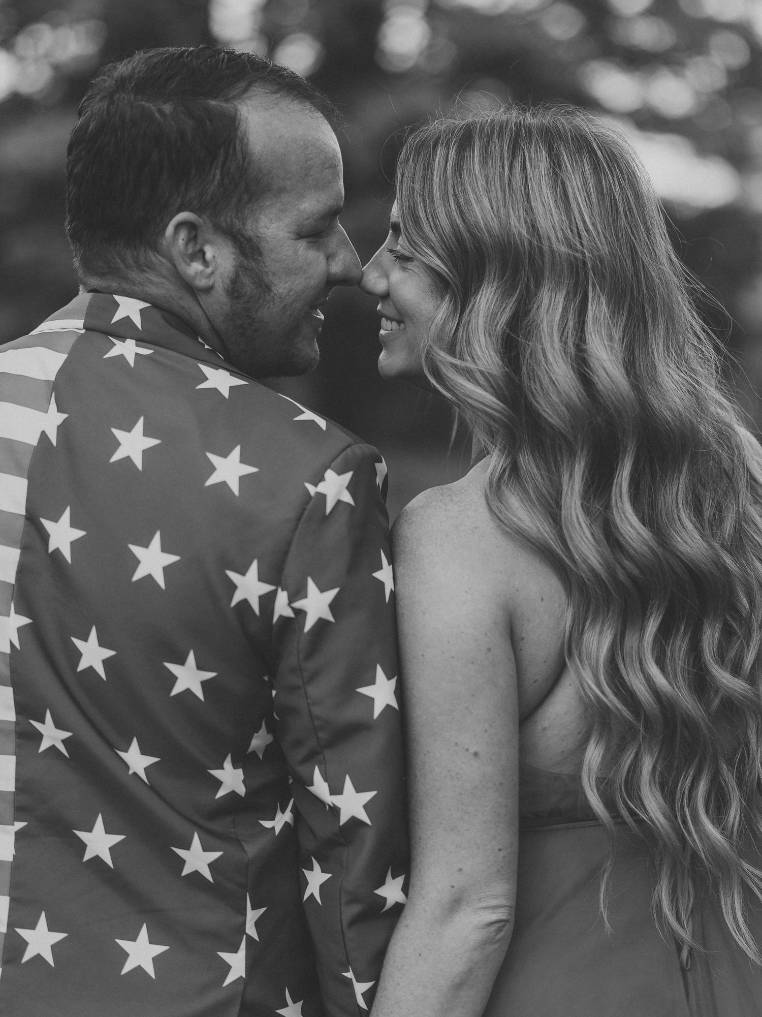 Black and white photo series showing a romantic couple embracing while wearing a star-patterned outfit.