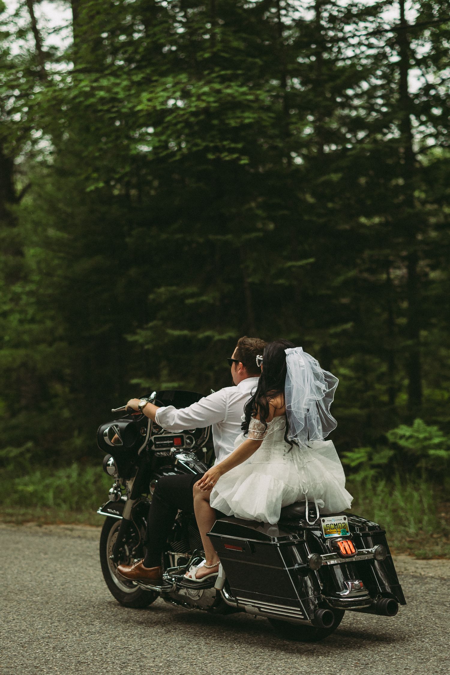 Motorcycle photoshoot series showing dynamic poses against forest backdrop.