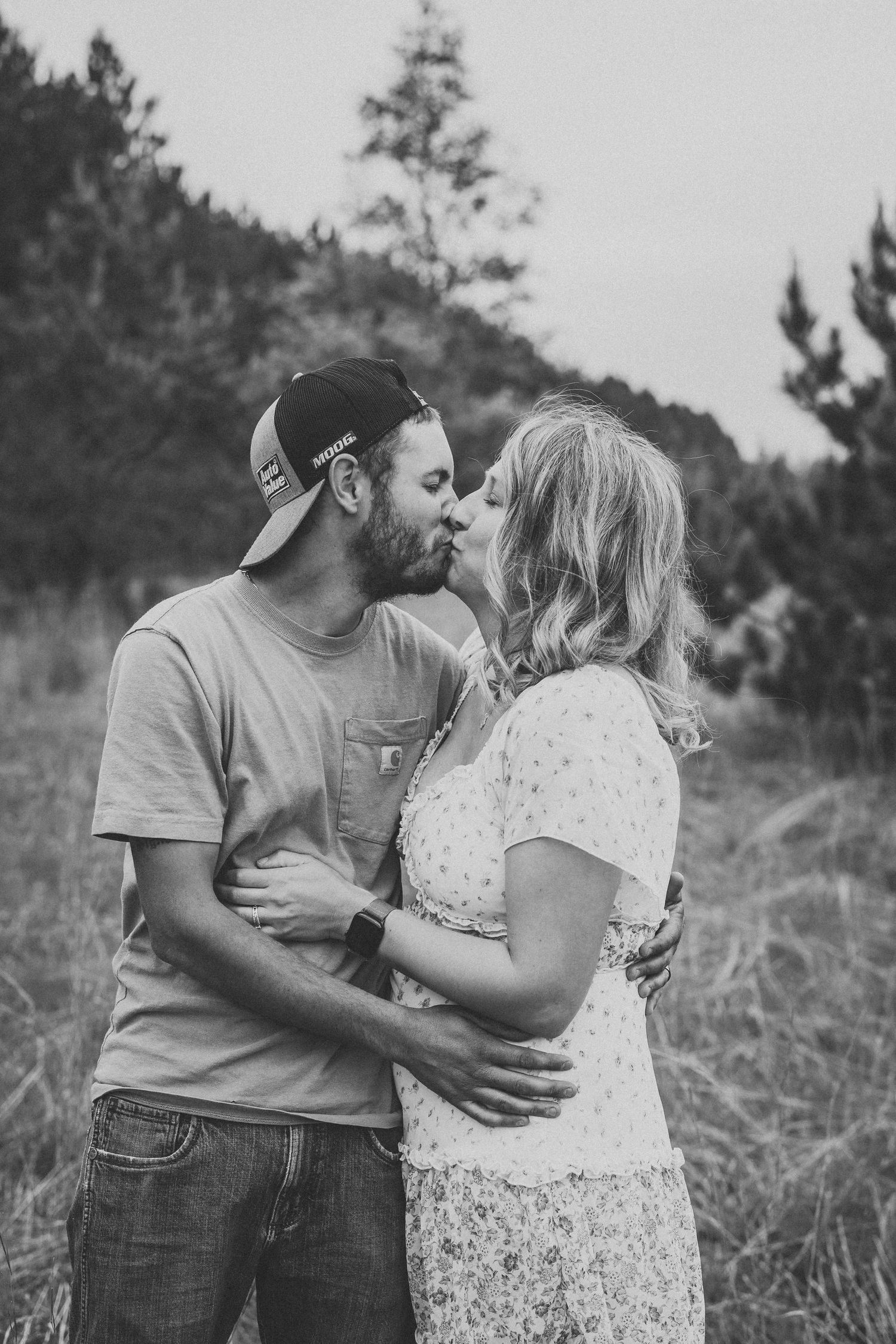 A series of intimate black and white family portraits captured in an outdoor setting.
