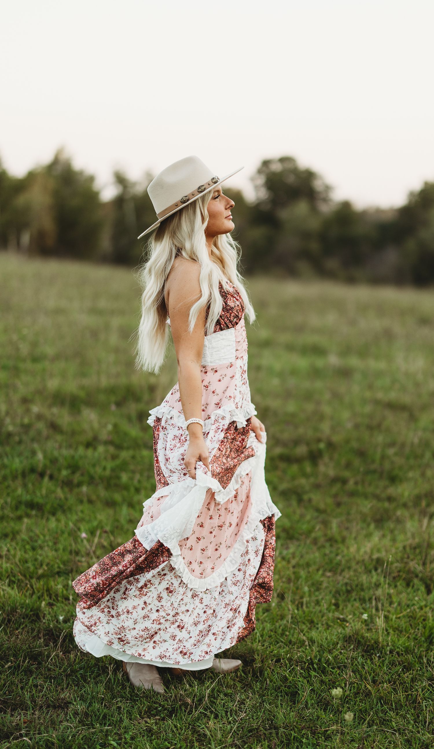 Flowing floral dress movement captured in an outdoor field during golden hour.