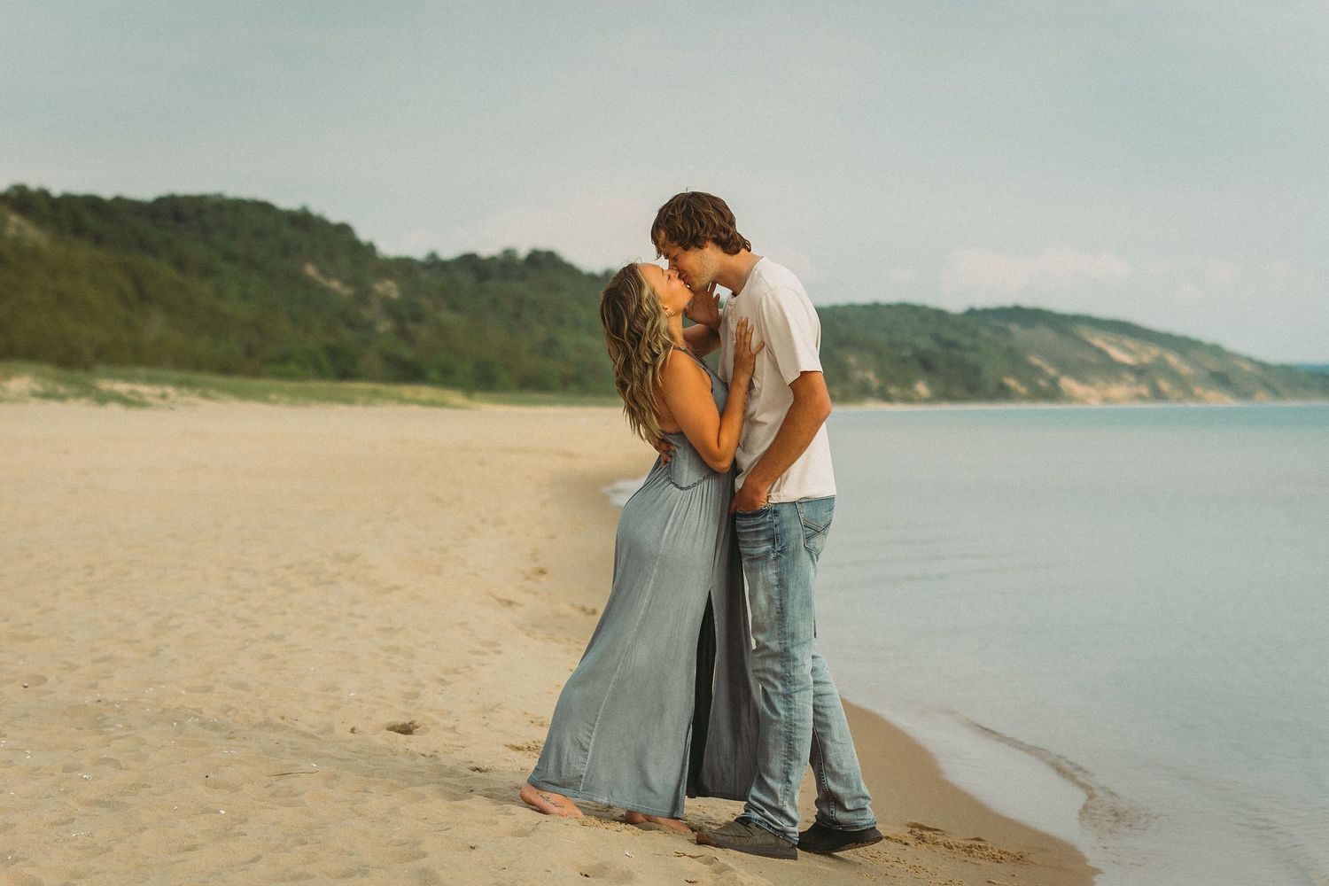 A series of romantic beach photos with soft teal tones showing tender embraces.