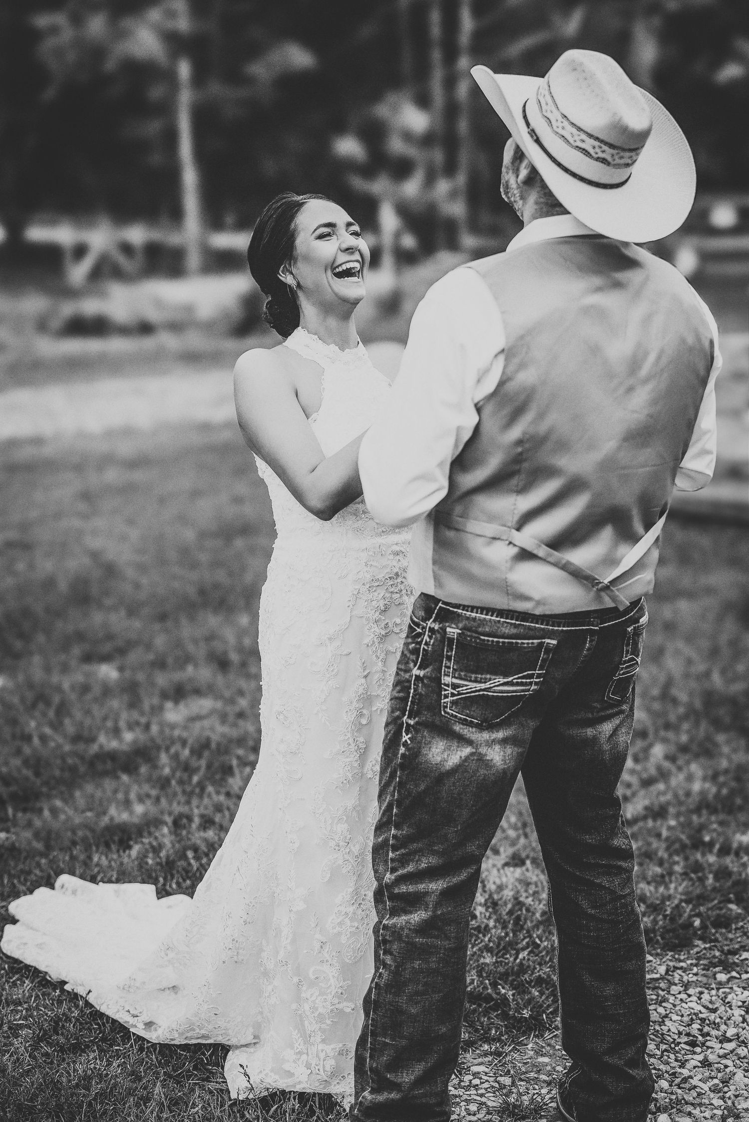A romantic black and white photo series showing a couple dancing together outdoors, with the bride in white and groom in jeans.