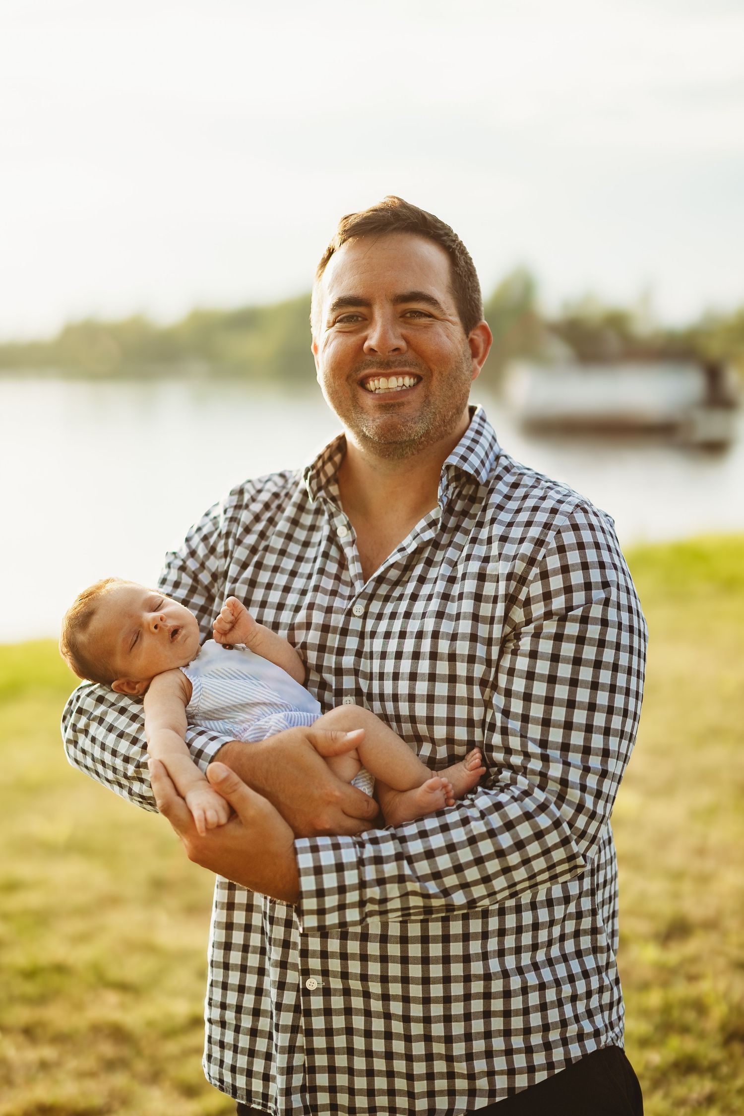 A heartwarming outdoor photo series showing tender moments between parent and infant during golden hour.