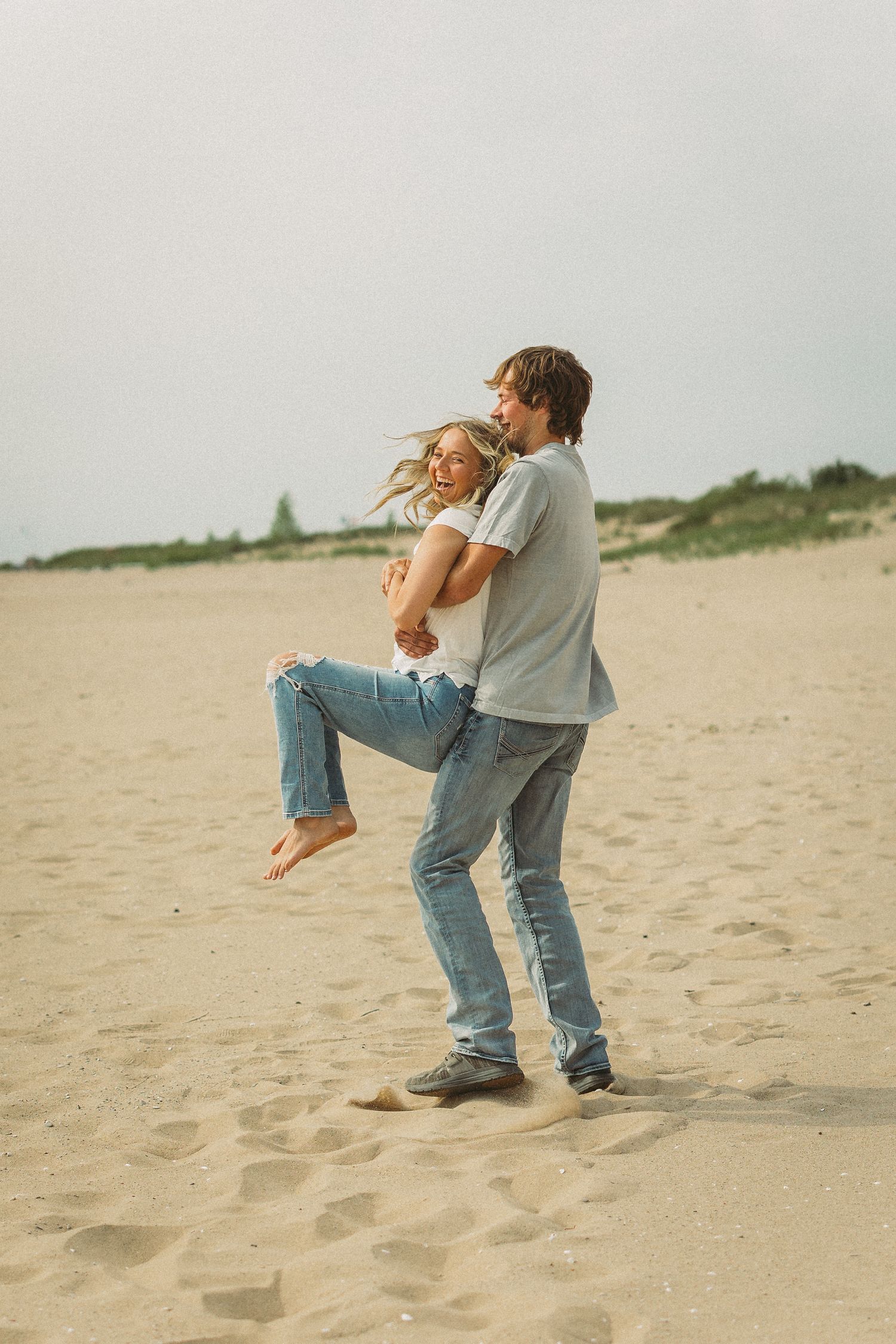 Playful beach photography sequence showing joyful moments and lifts on the sand.