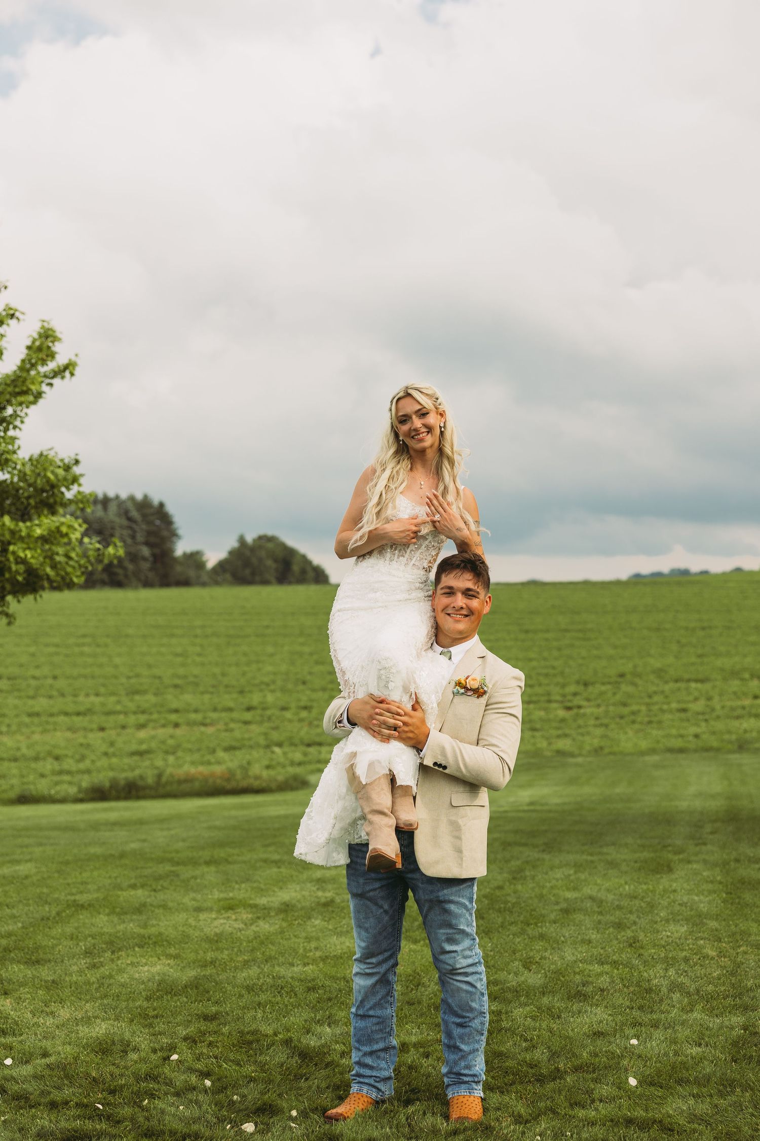 Romantic outdoor wedding photos taken in rustic farm setting with rolling green hills.