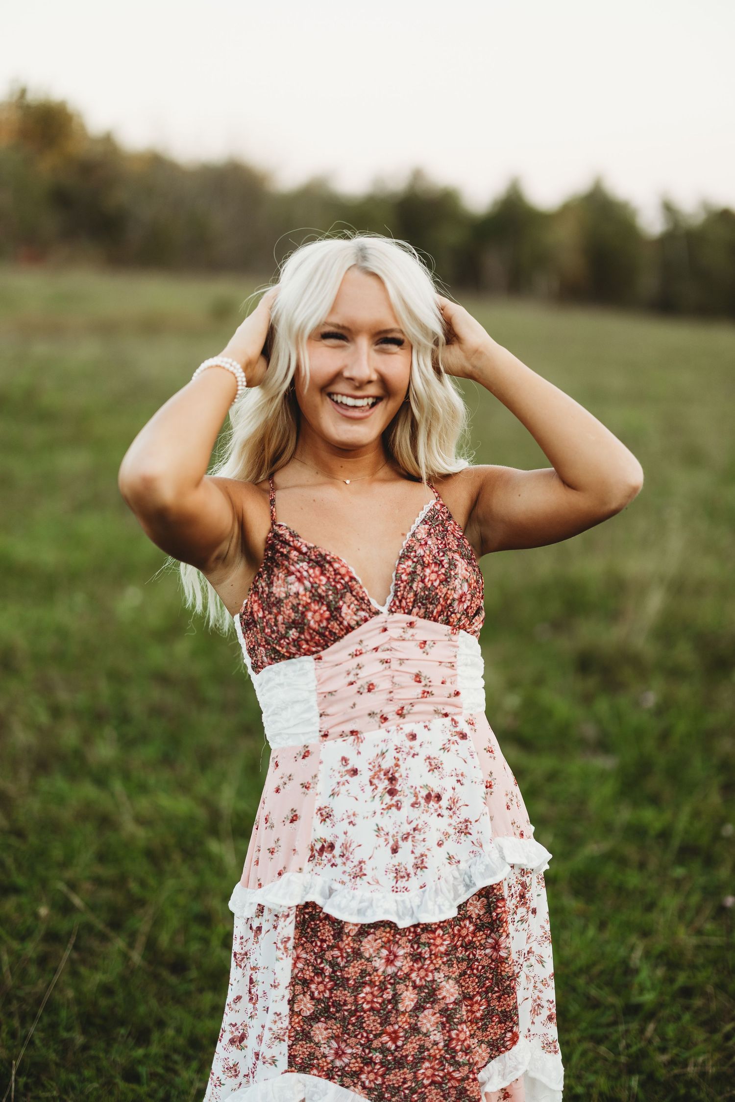 Candid outdoor portrait wearing a pink and white floral summer dress.