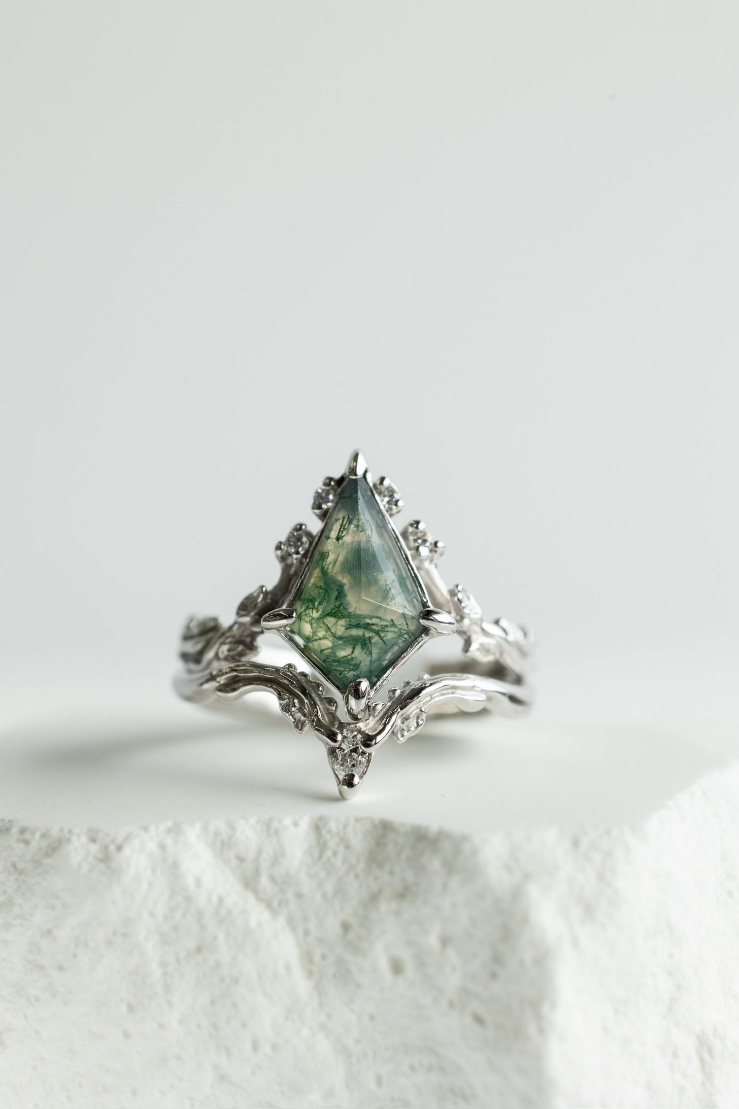 Elegant silver ring with seafoam green crystal in vintage-style setting on white surface.