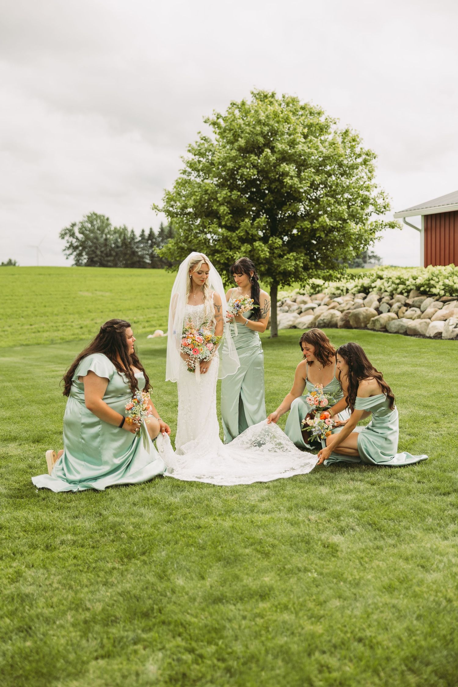 A series of candid photos showing bridesmaids in mint green dresses sitting on grass with a bride in white.