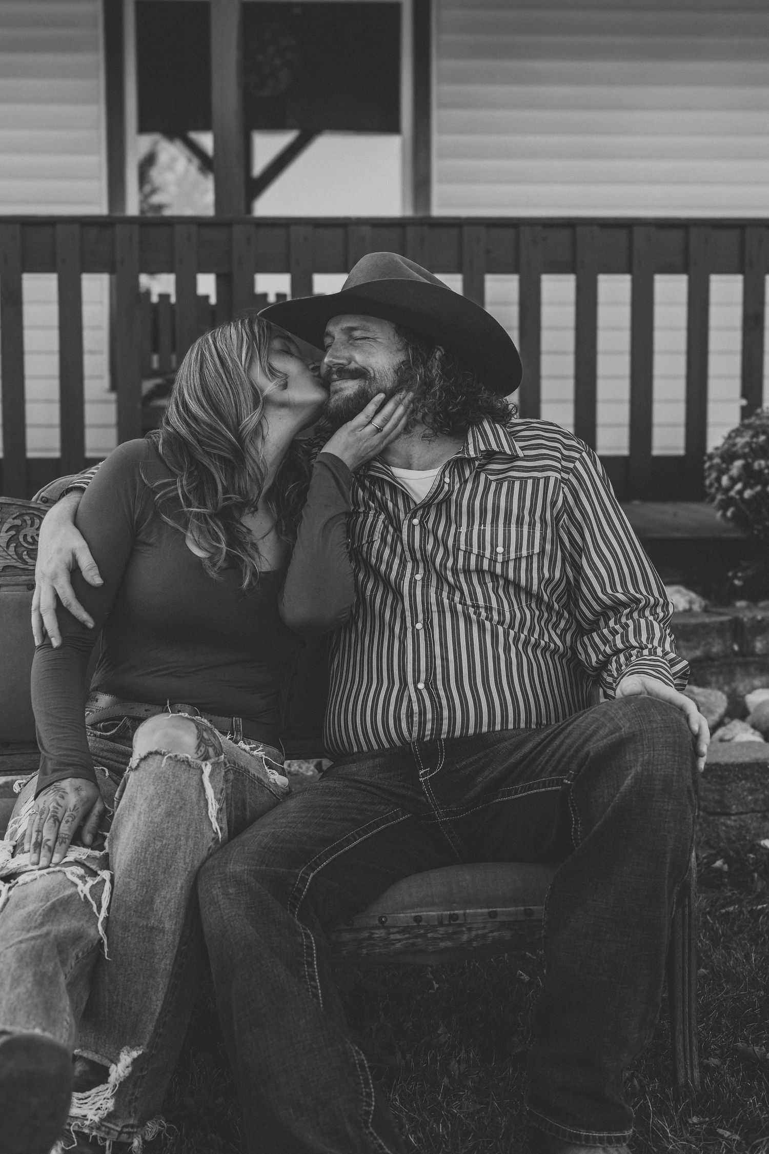 A black and white photo series shows a couple in striped shirt and jeans embracing on a couch.