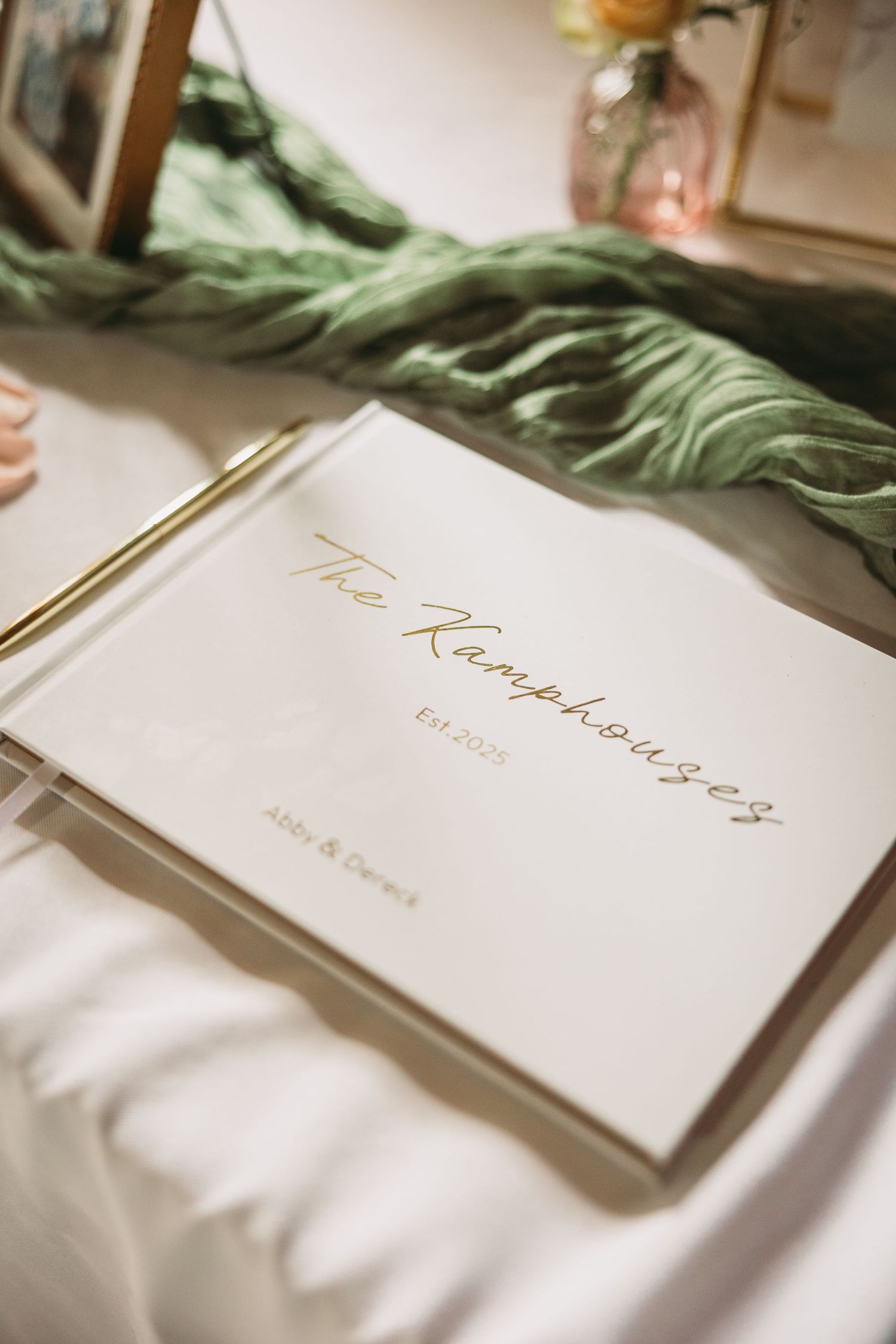 Elegant wedding place cards with gold calligraphy displayed on white linens.