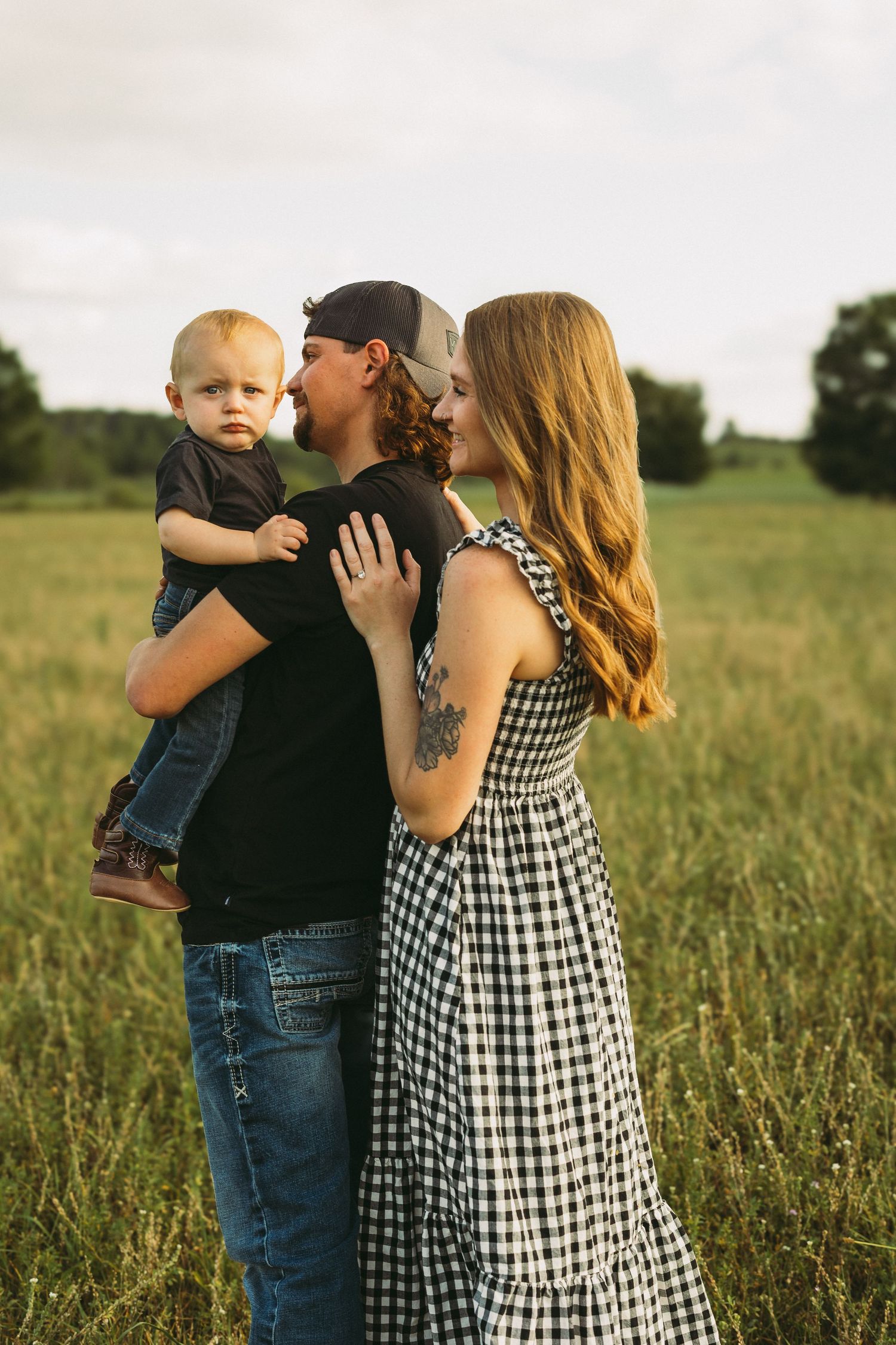 Family sharing joyful moments together in a golden summer field at sunset.