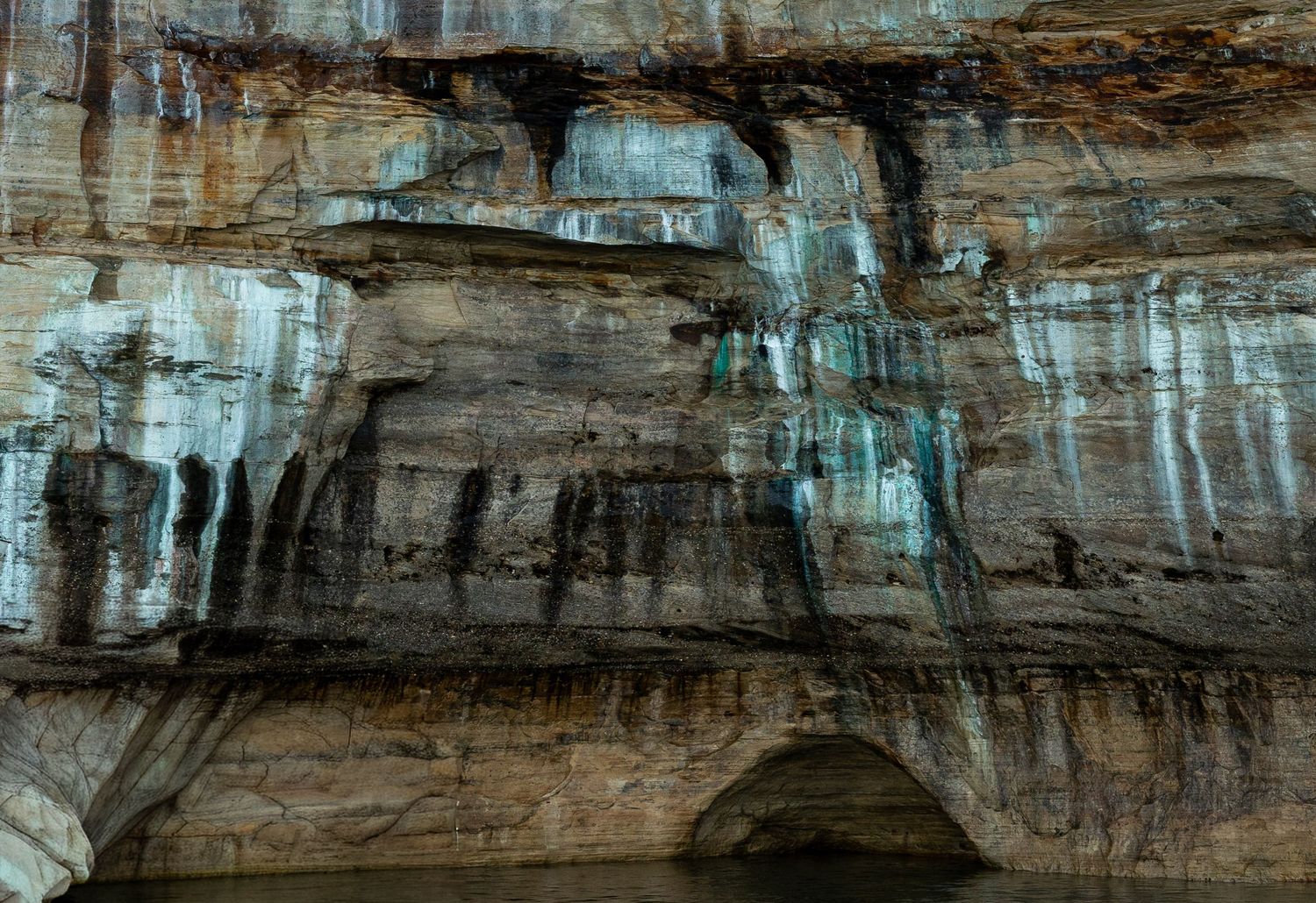 Detailed view of stratified rock layers in massive limestone cliff face.