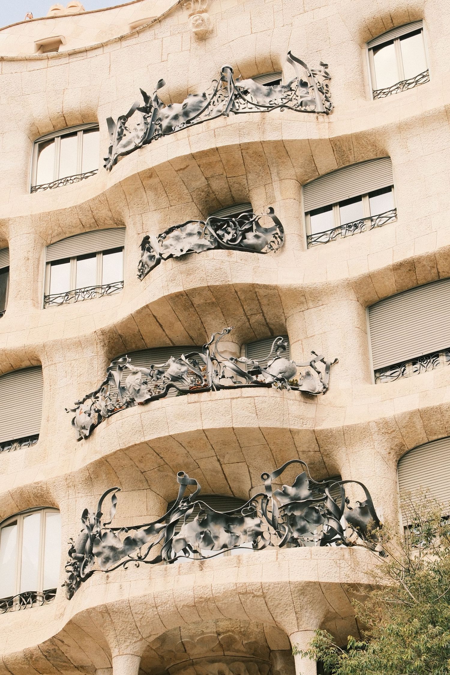 Close-up of Casa Mila La Pedrera facade with iconic wrought iron balconies by Antoni Gaudi in Barcelona.