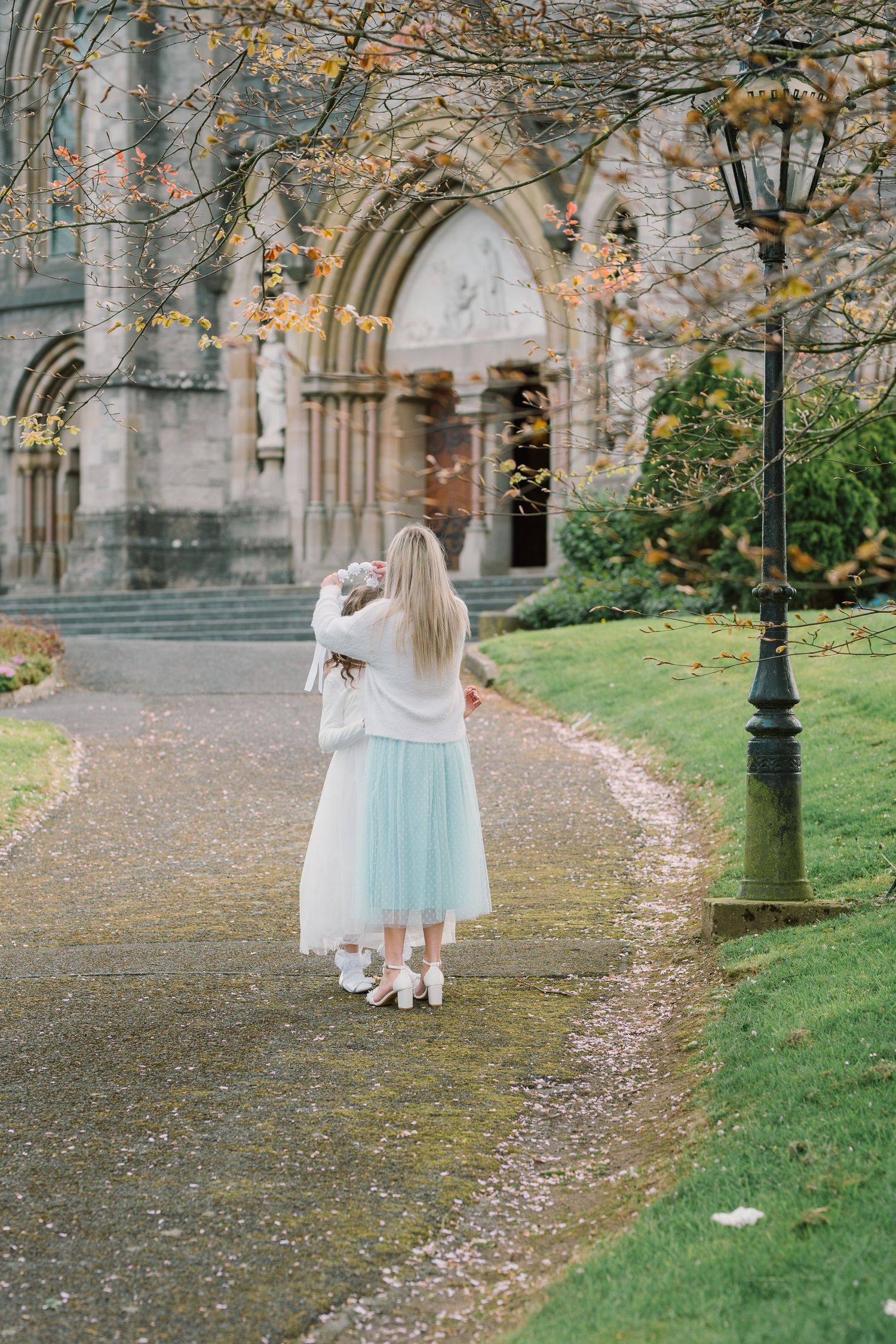 Communion in Monaghan cathedral, mom fixing daughter's veil just before the ceremony starts