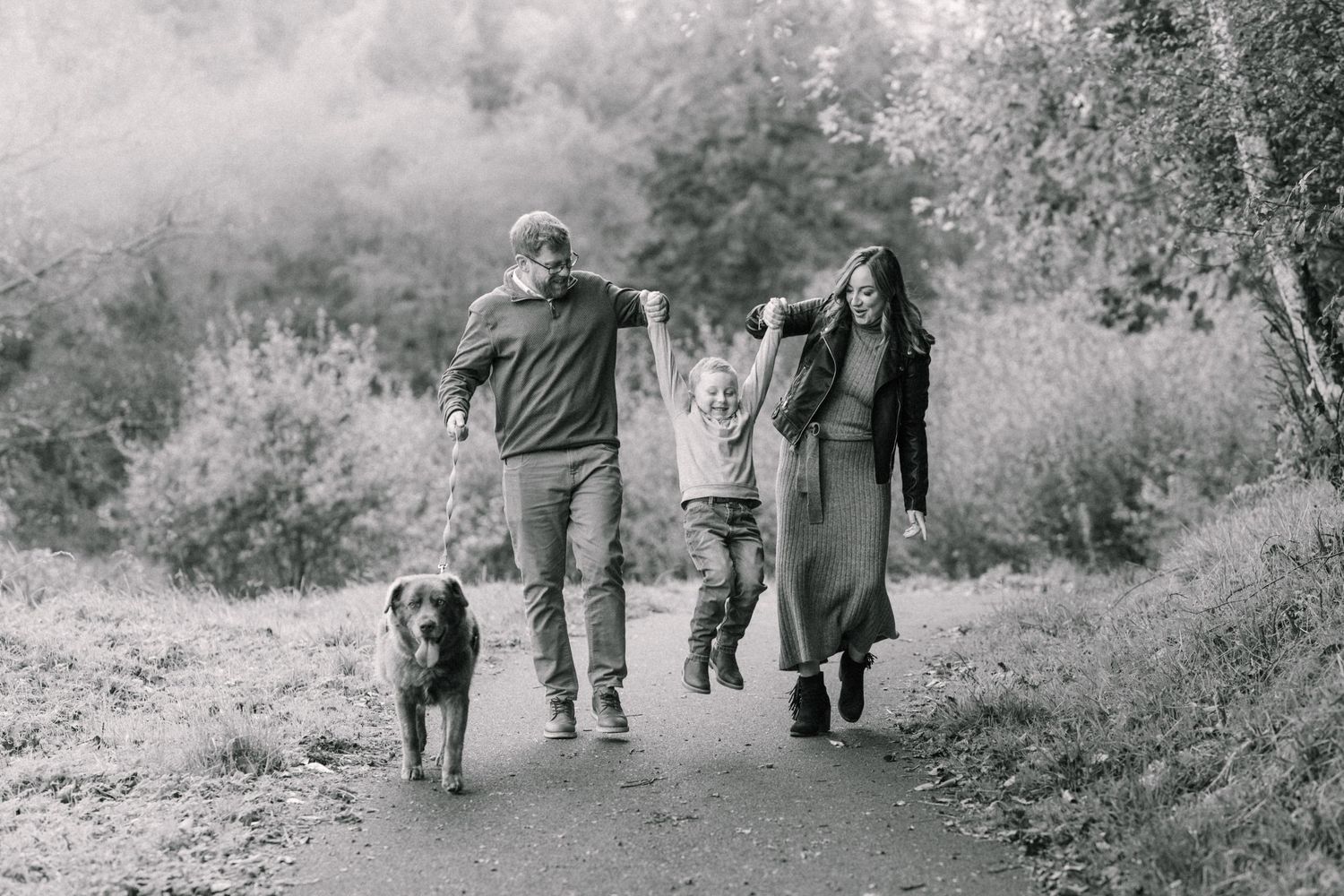 Black and white image happy family with dog walk in the park Monaghan