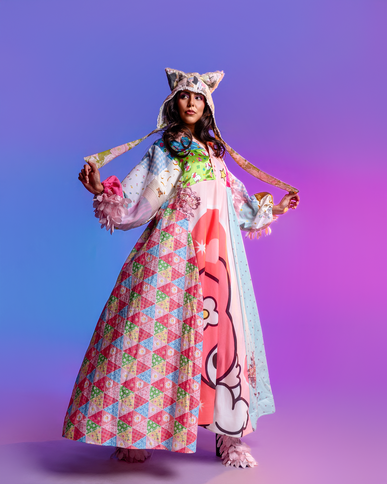 Fashion model wearing a colorful floral dress with pink accents against a purple gradient background.