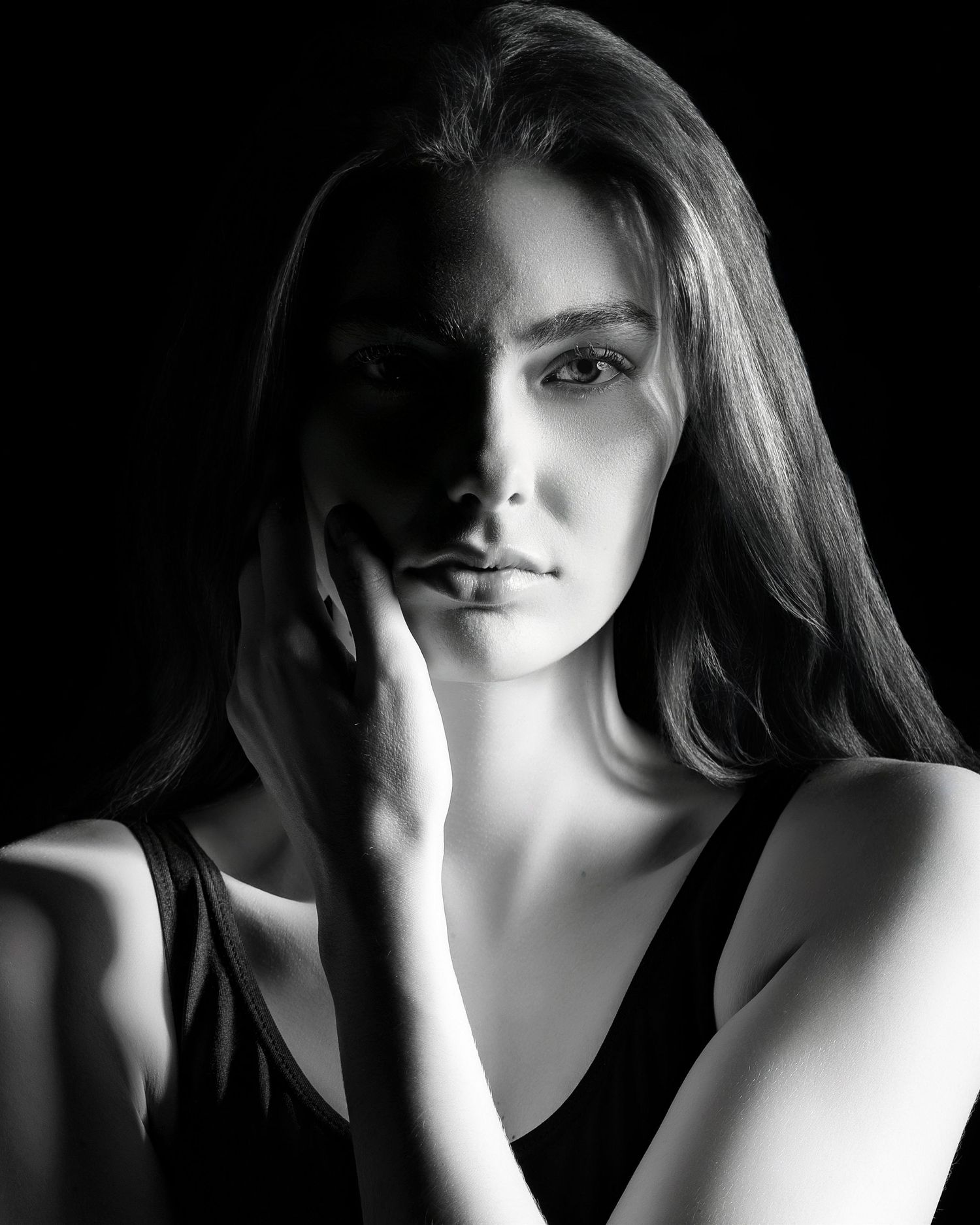 Dramatic black and white portrait series showing different angles and shadows in a moody artistic style.