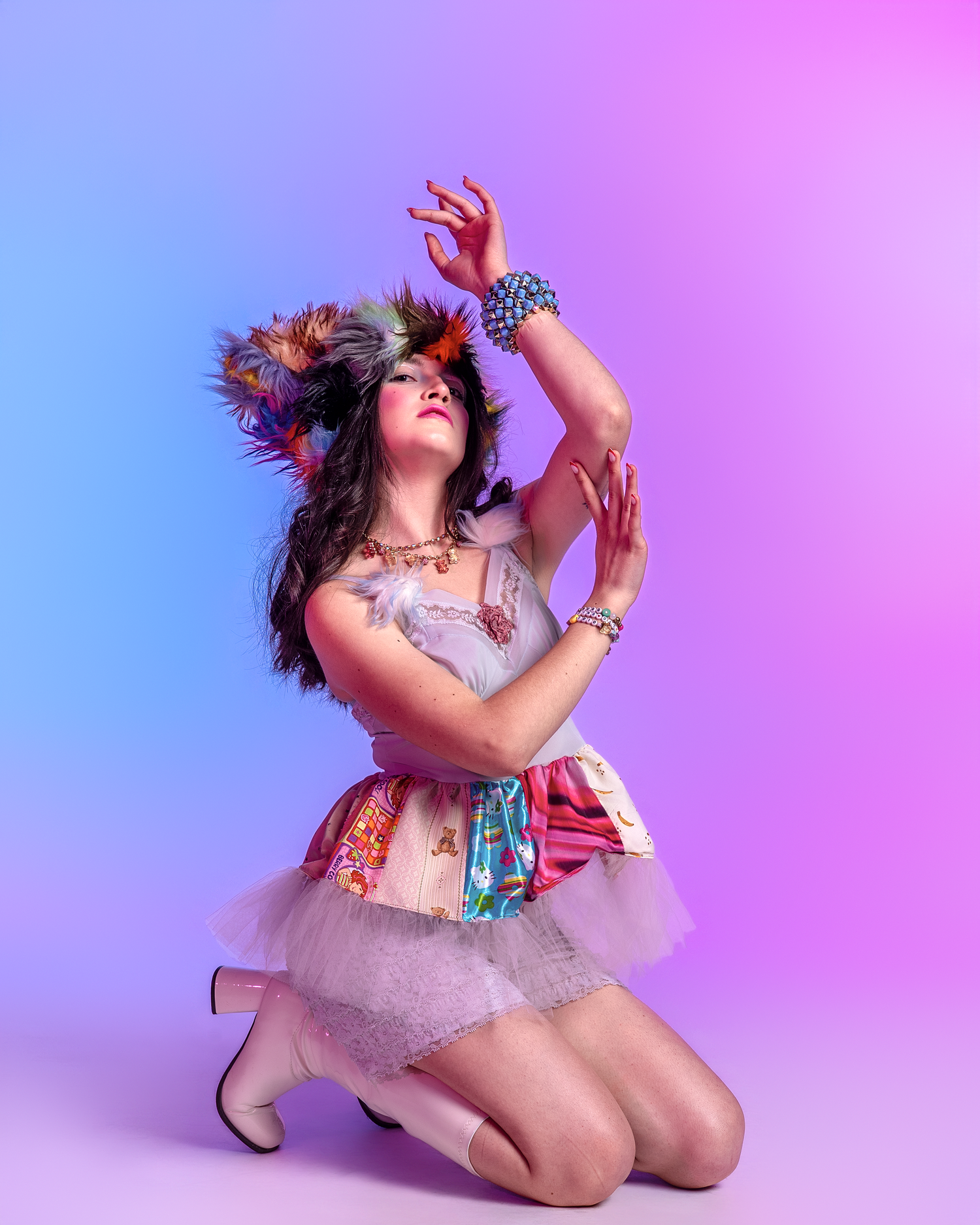 Dynamic low-angle shot of performer in white tulle outfit against gradient purple background.