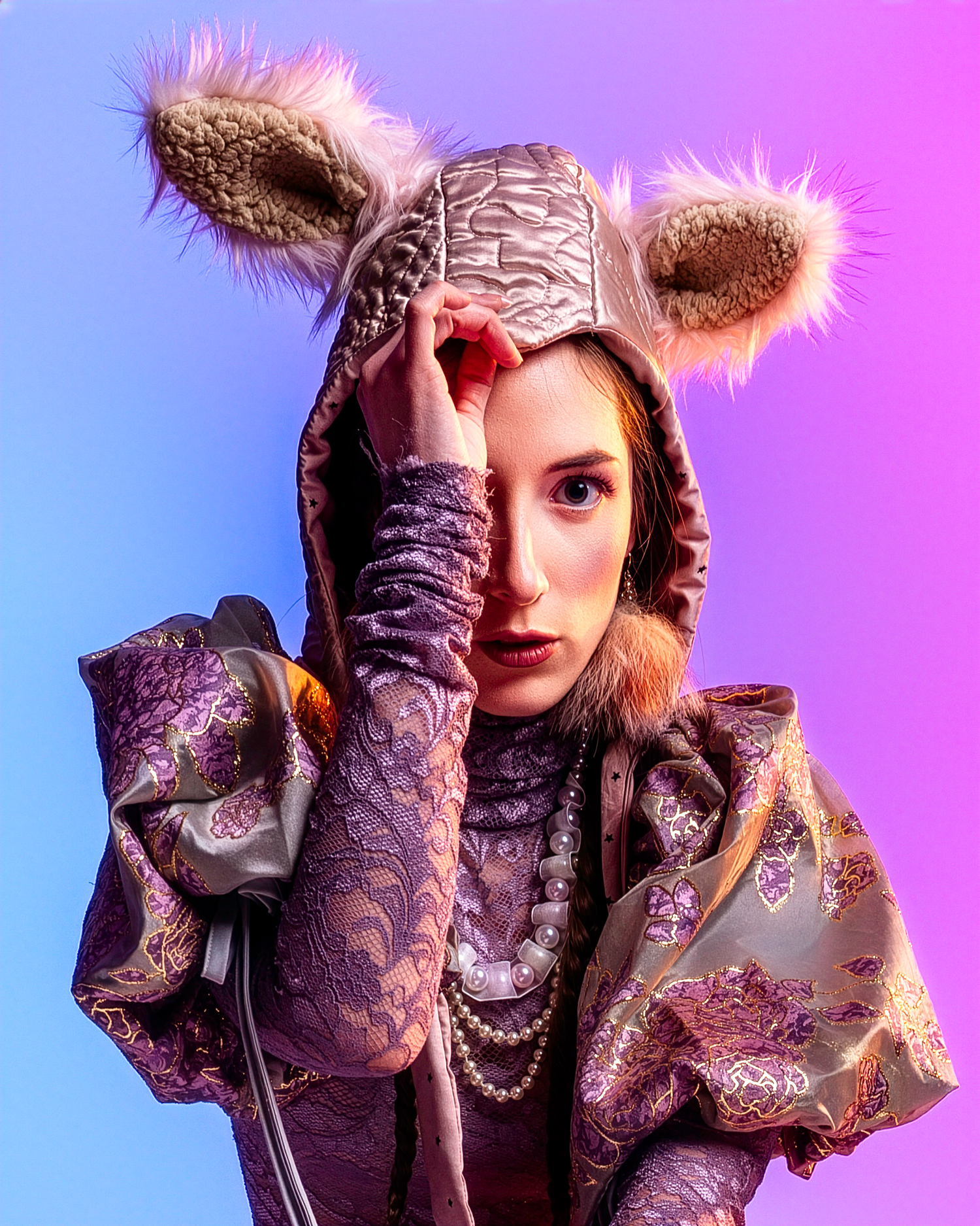 Close-up fashion portrait featuring purple lace dress and furry accessories.
