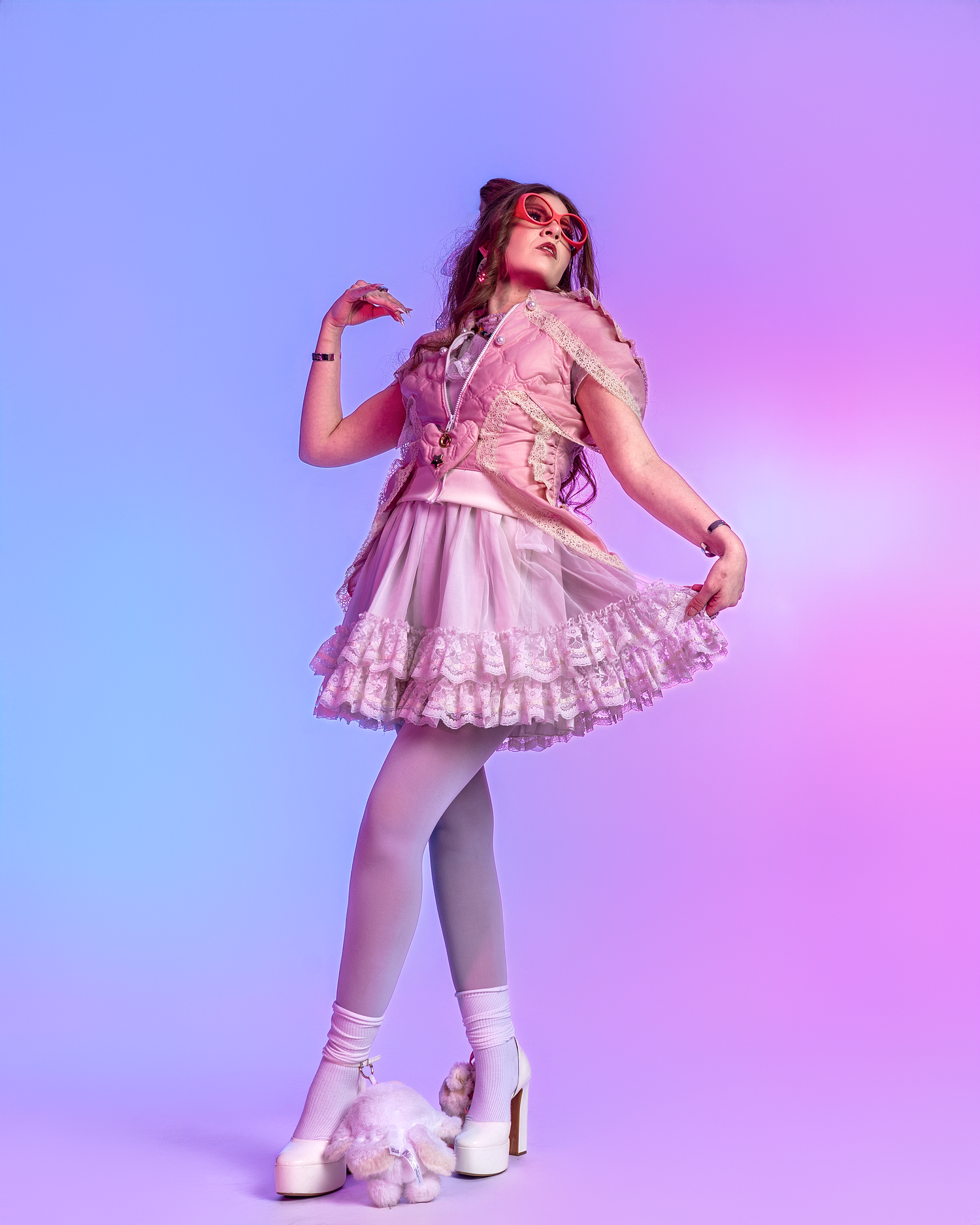Figure wearing pink dress and white boots strikes dynamic pose on gradient backdrop.