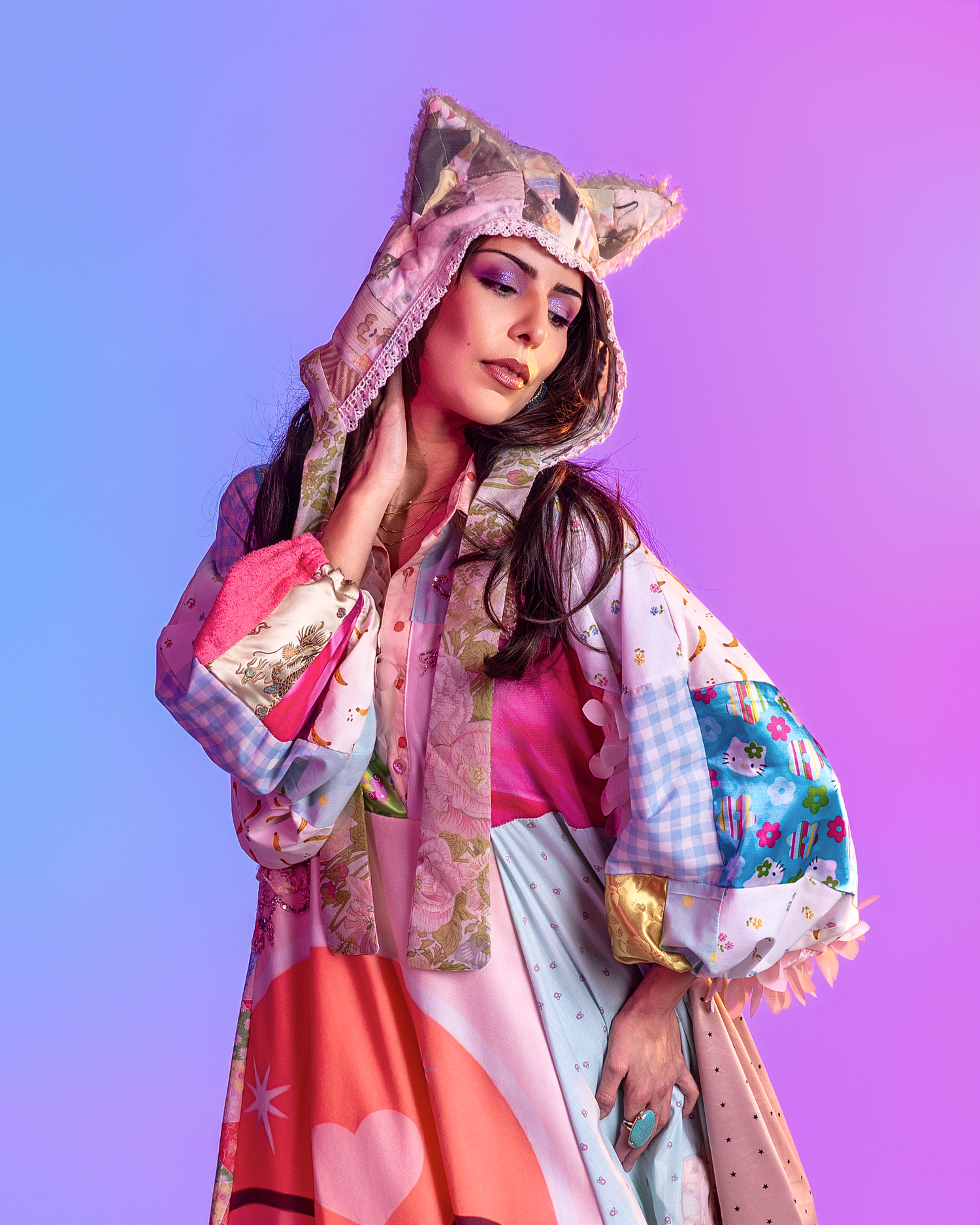 Artistic fashion photo with model in pink dress and accessories against gradient purple backdrop.