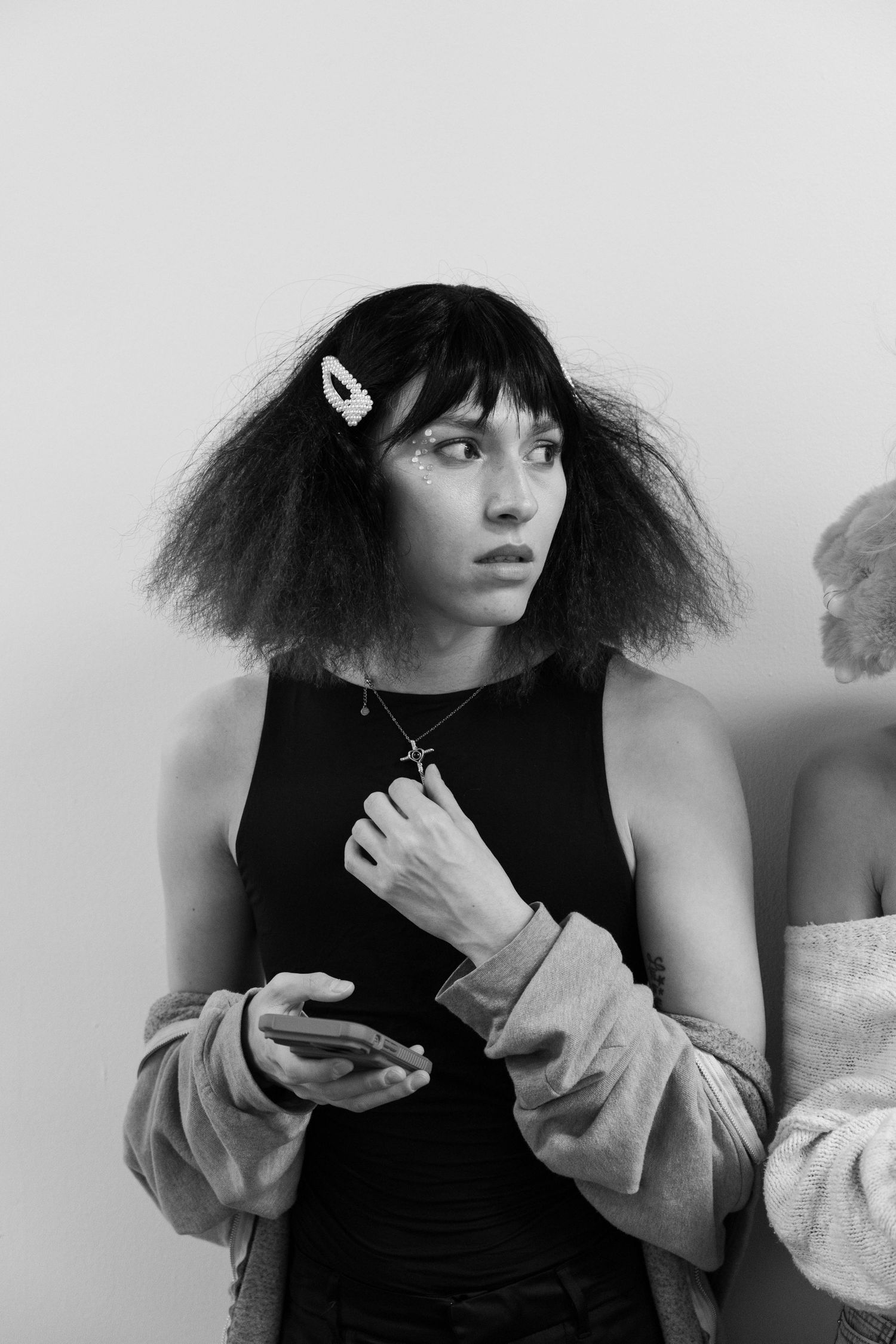 Black and white portrait series showing dramatic hairstyle and fashion poses.