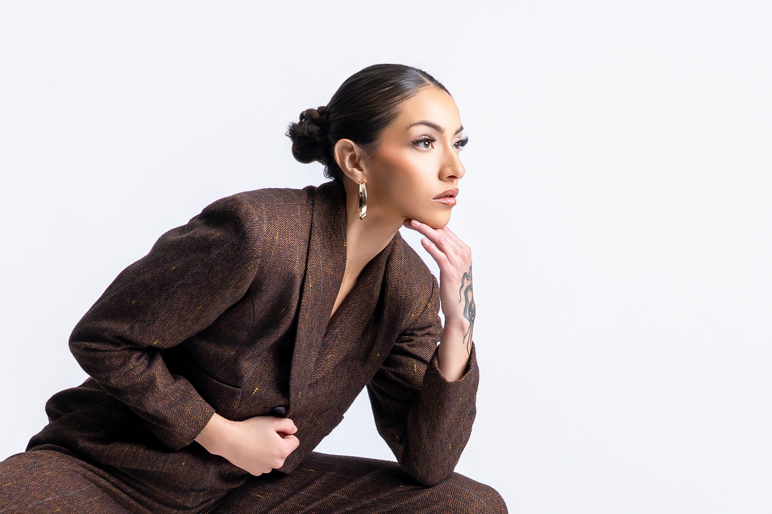 Elegant portrait series showcasing sophisticated poses in dark brown attire.